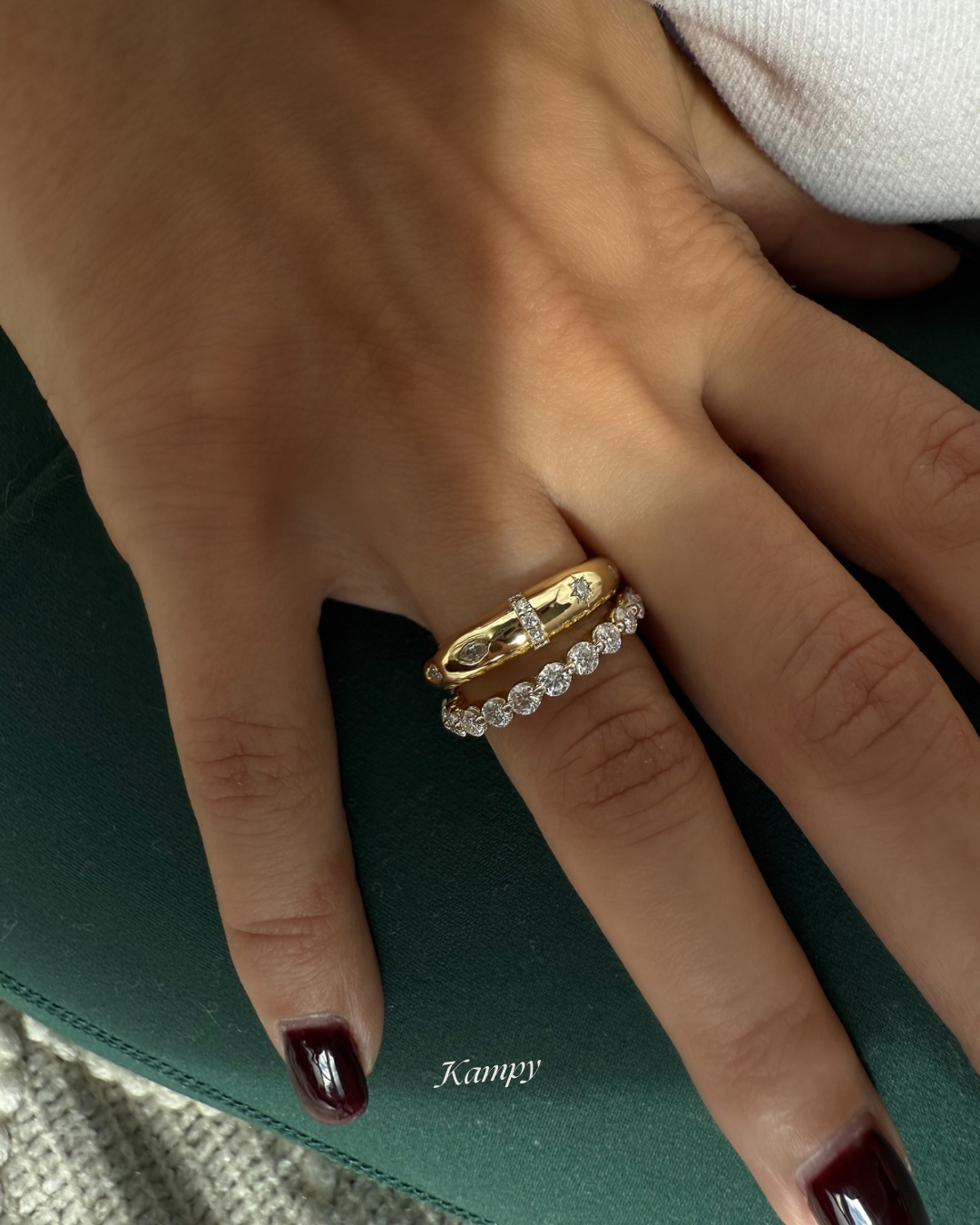 Round moissanite eternity band stacked with dome star ring on model hand, Kampy Designs