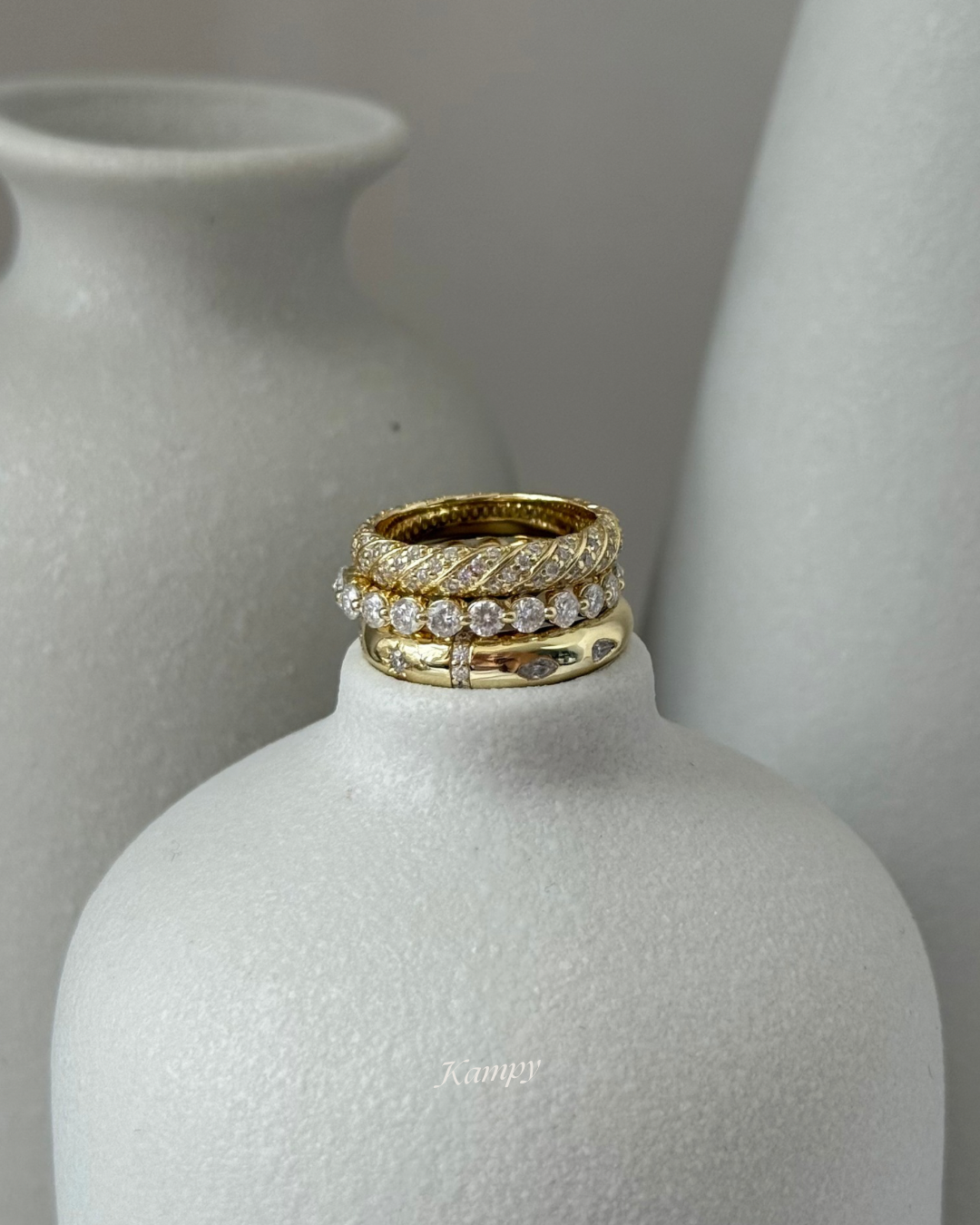 Moissanite ring stack set styled on ceramic vase in studio, Kampy Designs