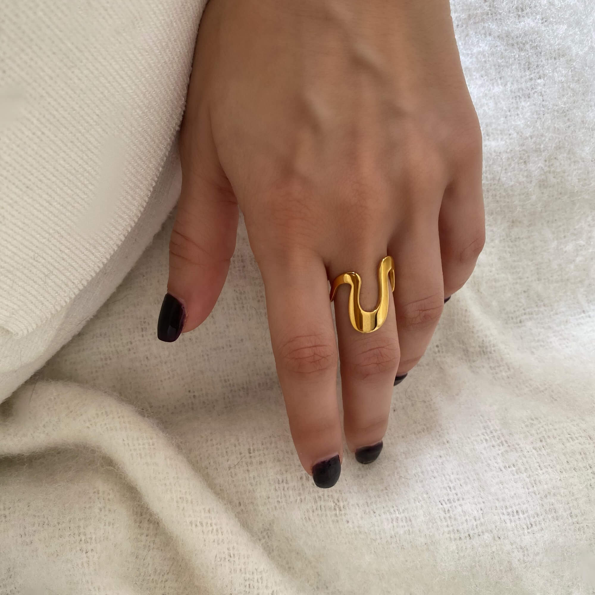 Close-up of the Abstract Liquid Metal Ring by Kampy Designs, detailing its smooth reflective surface and bold architectural form.