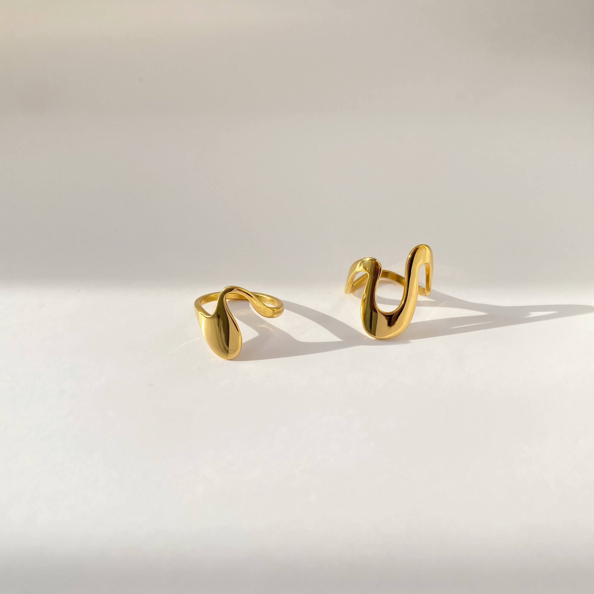 Flat lay of the Abstract Liquid Metal Ring by Kampy Designs, showcasing the bold reflective surface and fluid silhouette from above.