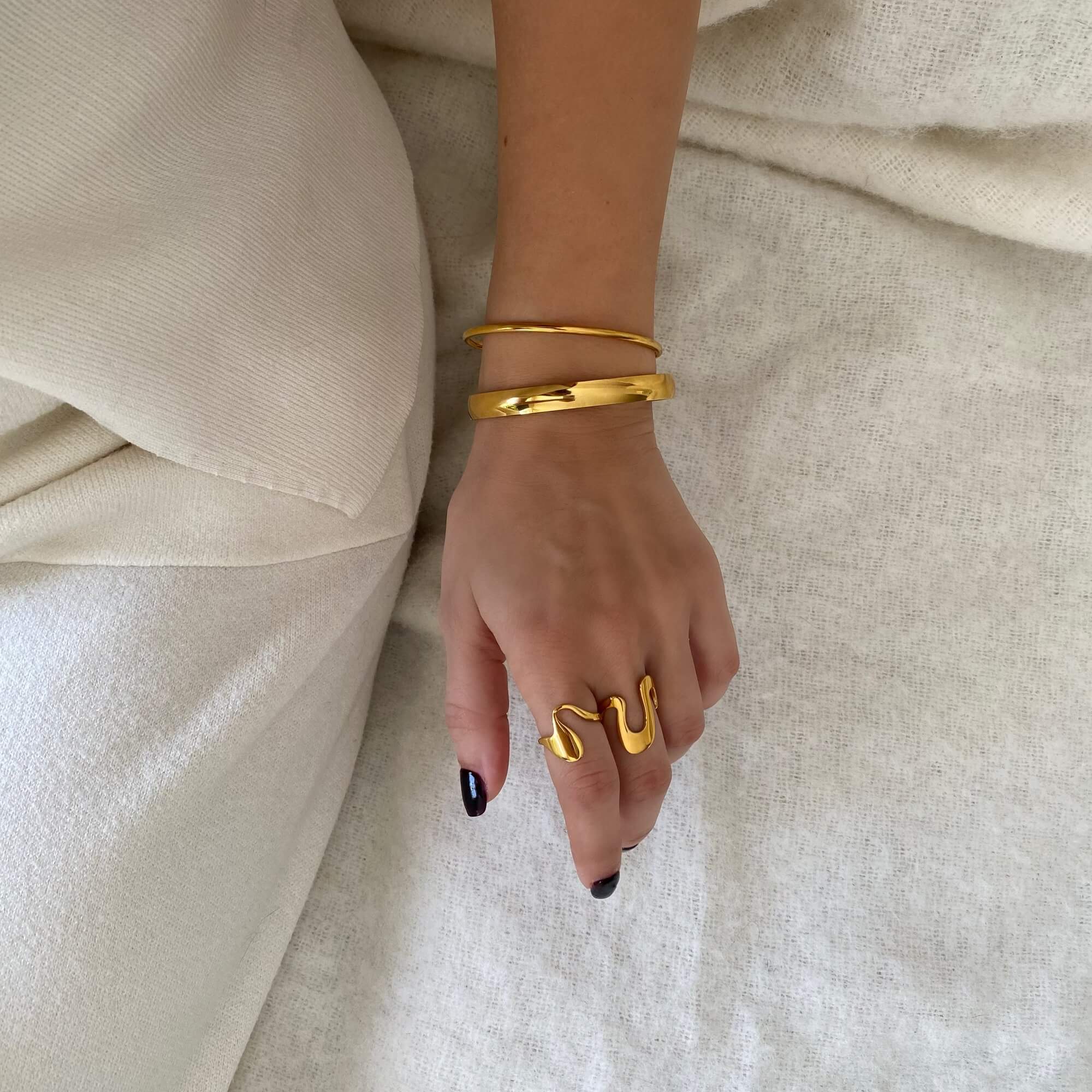 Full view of the Abstract Liquid Metal Ring by Kampy Designs, highlighting its unique asymmetrical curves and high-shine finish.