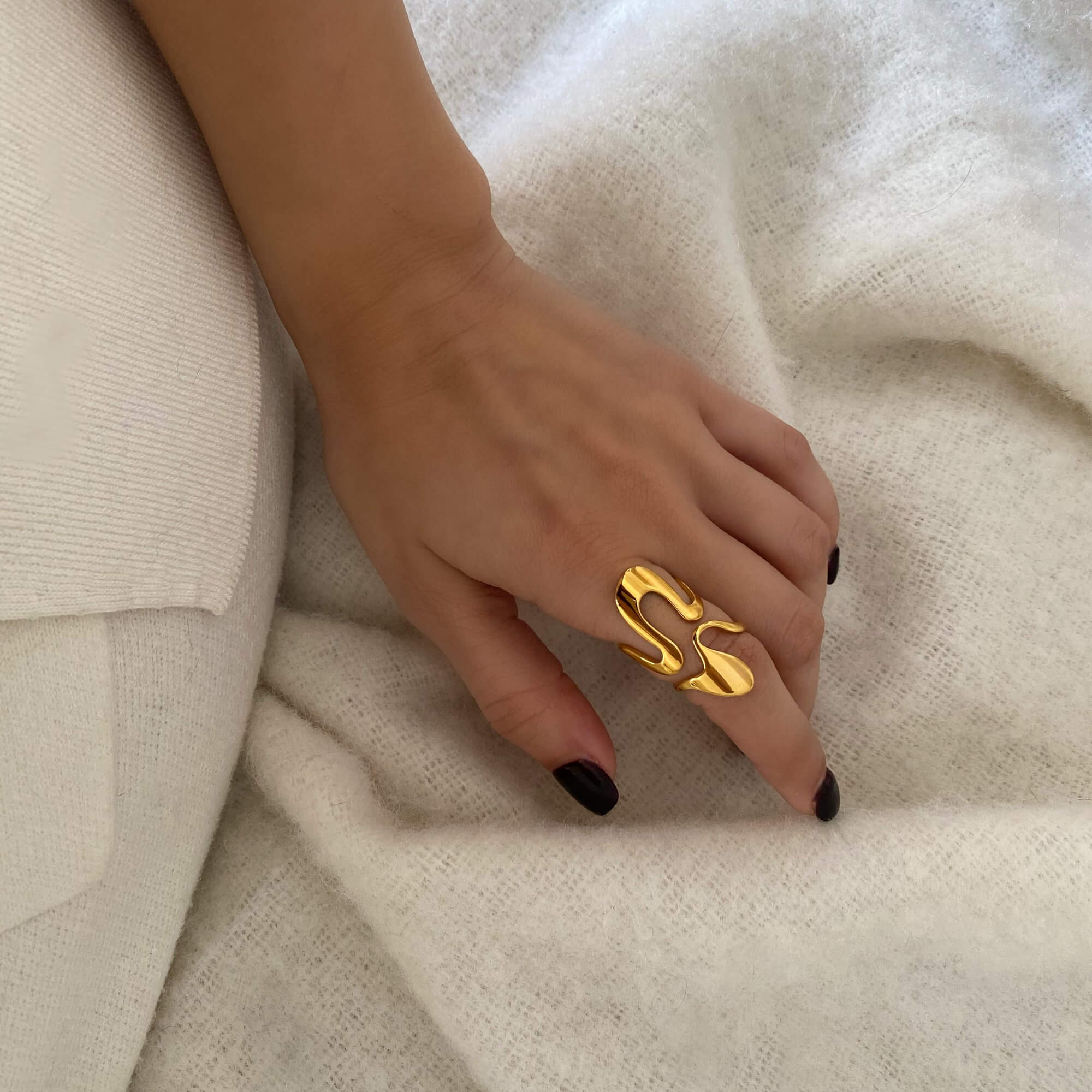 Stacked view of the Abstract Liquid Metal Ring by Kampy Designs, styled with other rings to create a bold, layered look.