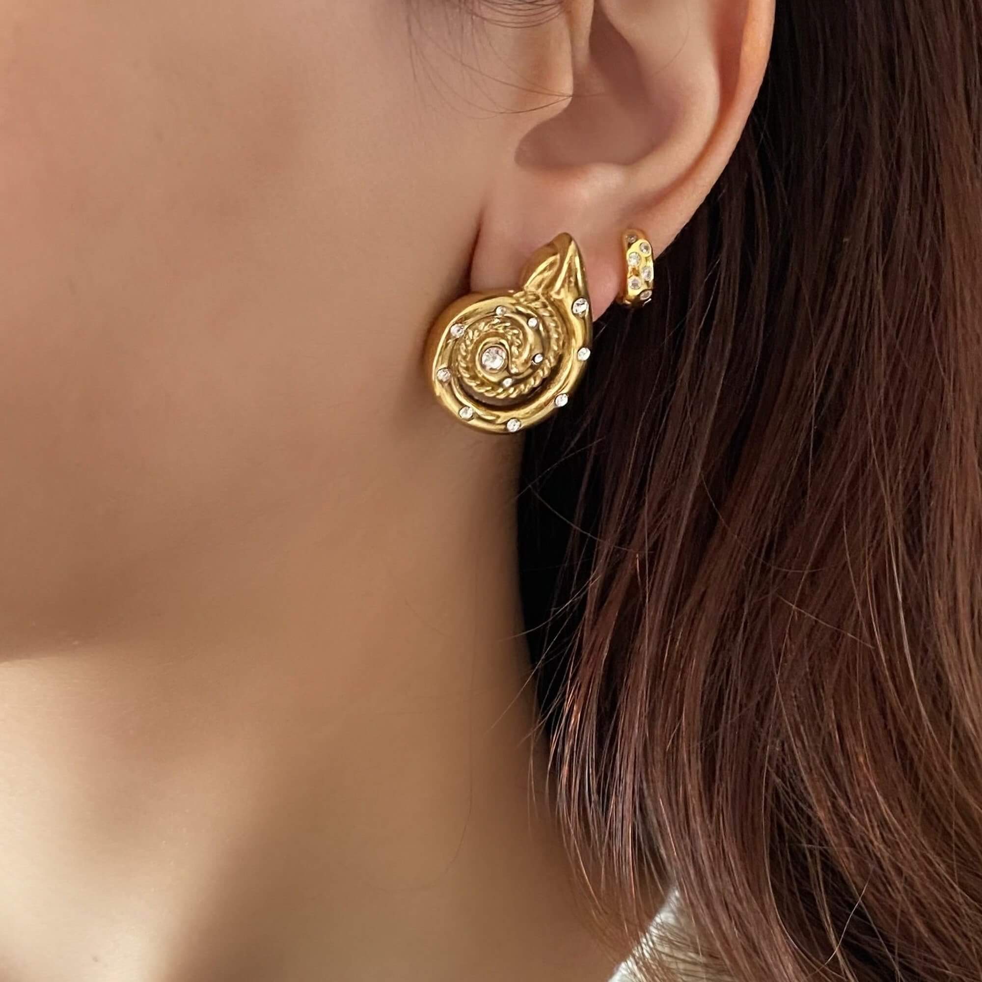The KipsyE bold CZ seashell stud earrings by Kampy Designs, elegantly styled with other jewelry for a sophisticated and beach-inspired look.