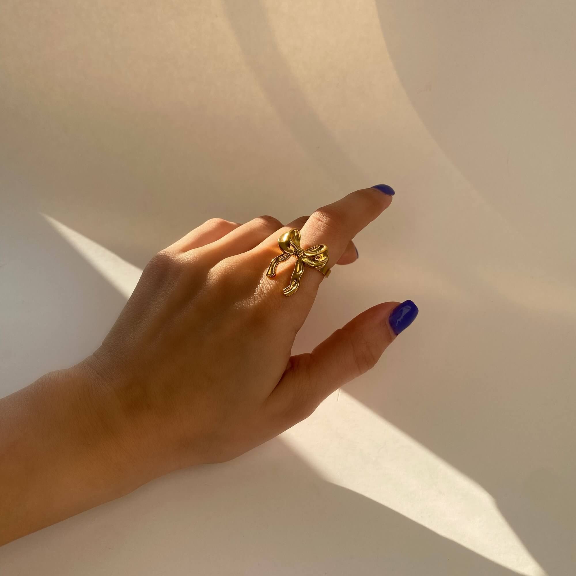 Close-up of the Kinikir bow statement ring by Kampy Designs, highlighting the smooth curves and detailed craftsmanship of the bow.