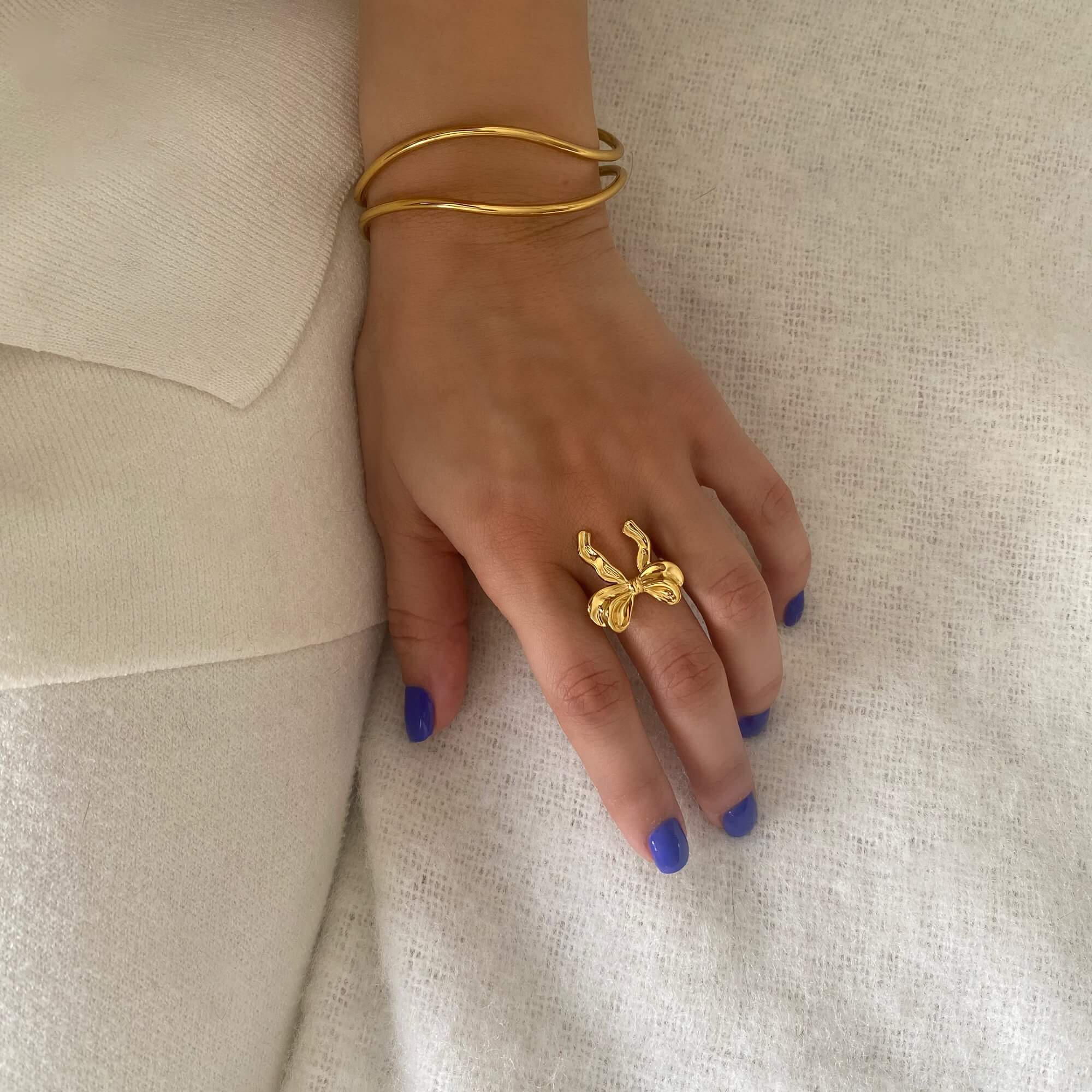 The Kinikir bow statement ring by Kampy Designs, worn on model’s hand to showcase its playful charm and striking design.