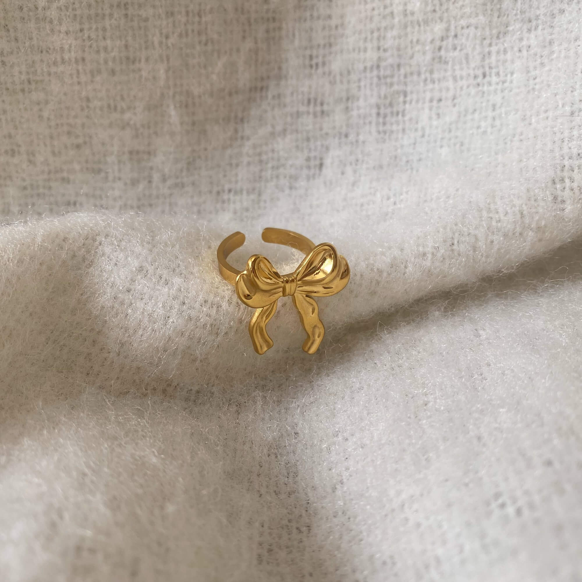Top view of the Kinikir bow statement ring by Kampy Designs, capturing the perfect symmetry and shine of the oversized bow.