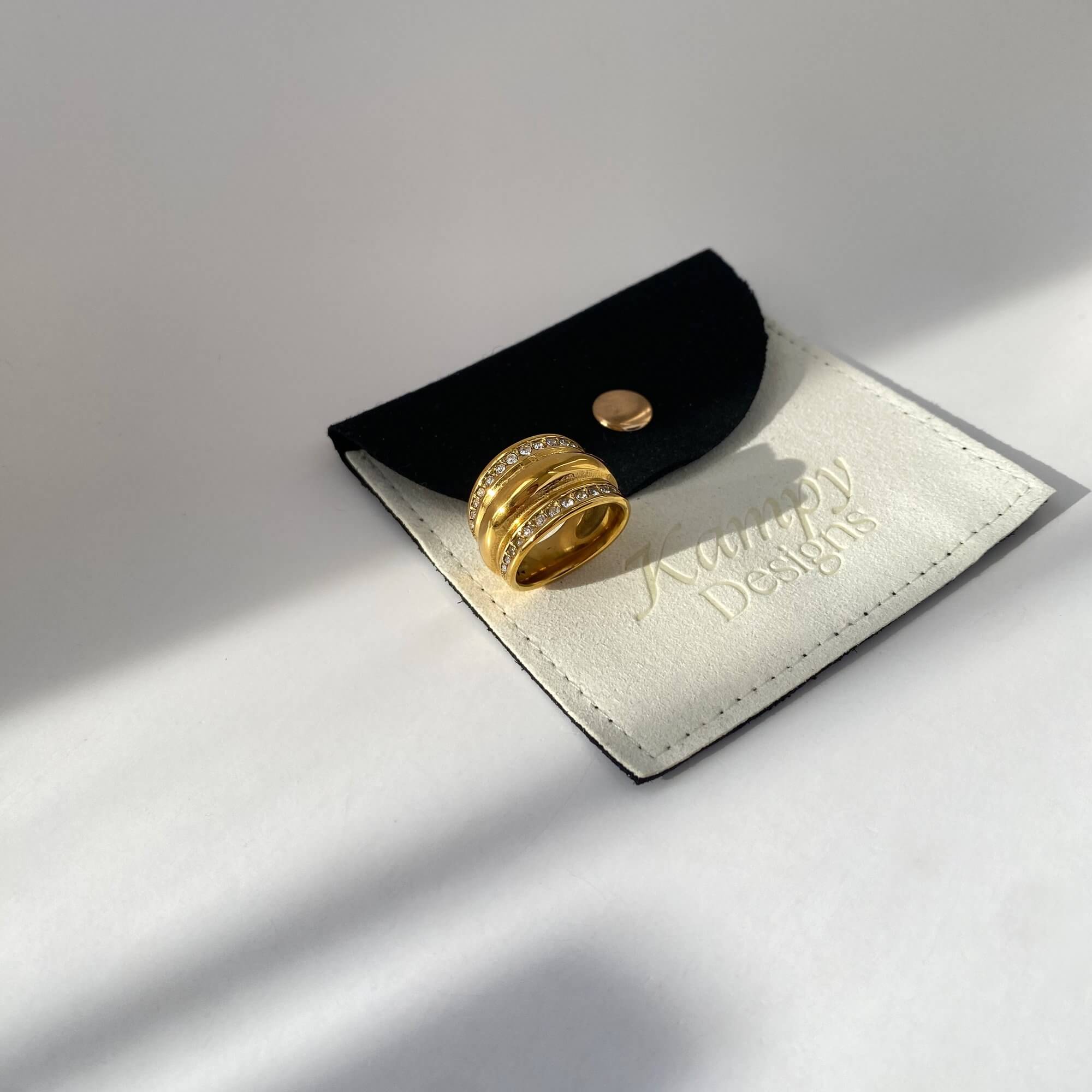 Close-up of the KatR chunky bubble ring by Kampy Designs, elegantly placed with branded packaging to emphasize luxury presentation.