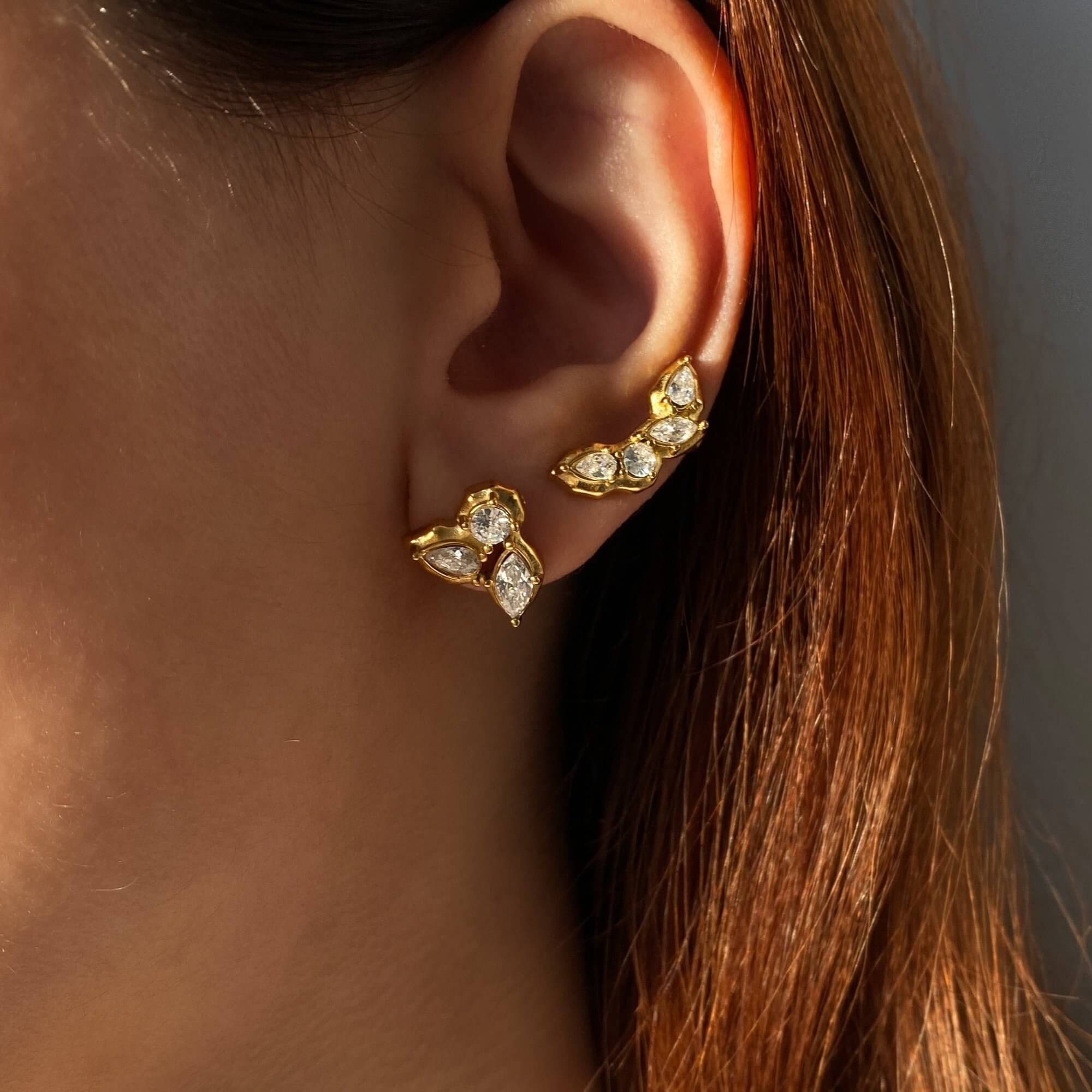Stacked view of the KarlaE cluster leaf CZ stud earrings by Kampy Designs, styled with multiple earrings for a chic layered look.