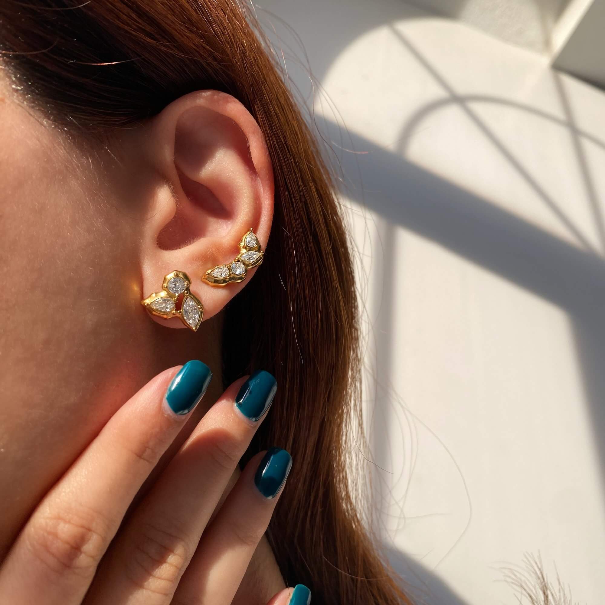 The KarlaE cluster leaf CZ stud earrings by Kampy Designs, elegantly worn to highlight their sophisticated sparkle and elegant leaf shape.