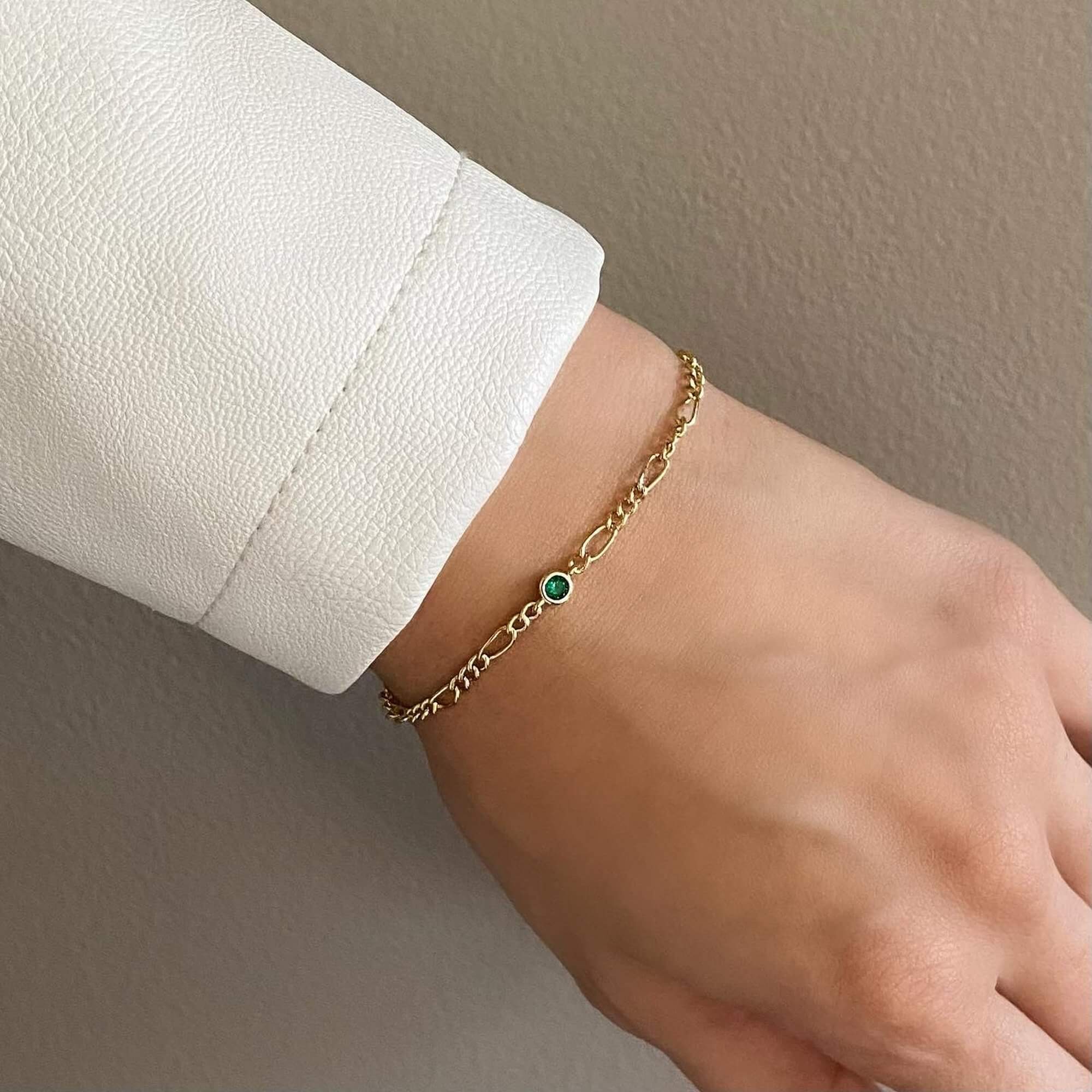 The KianaB CZ gemstone Figaro chain bracelet by Kampy Designs, featuring a rich emerald-green cubic zirconia stone for a timeless and elegant look.