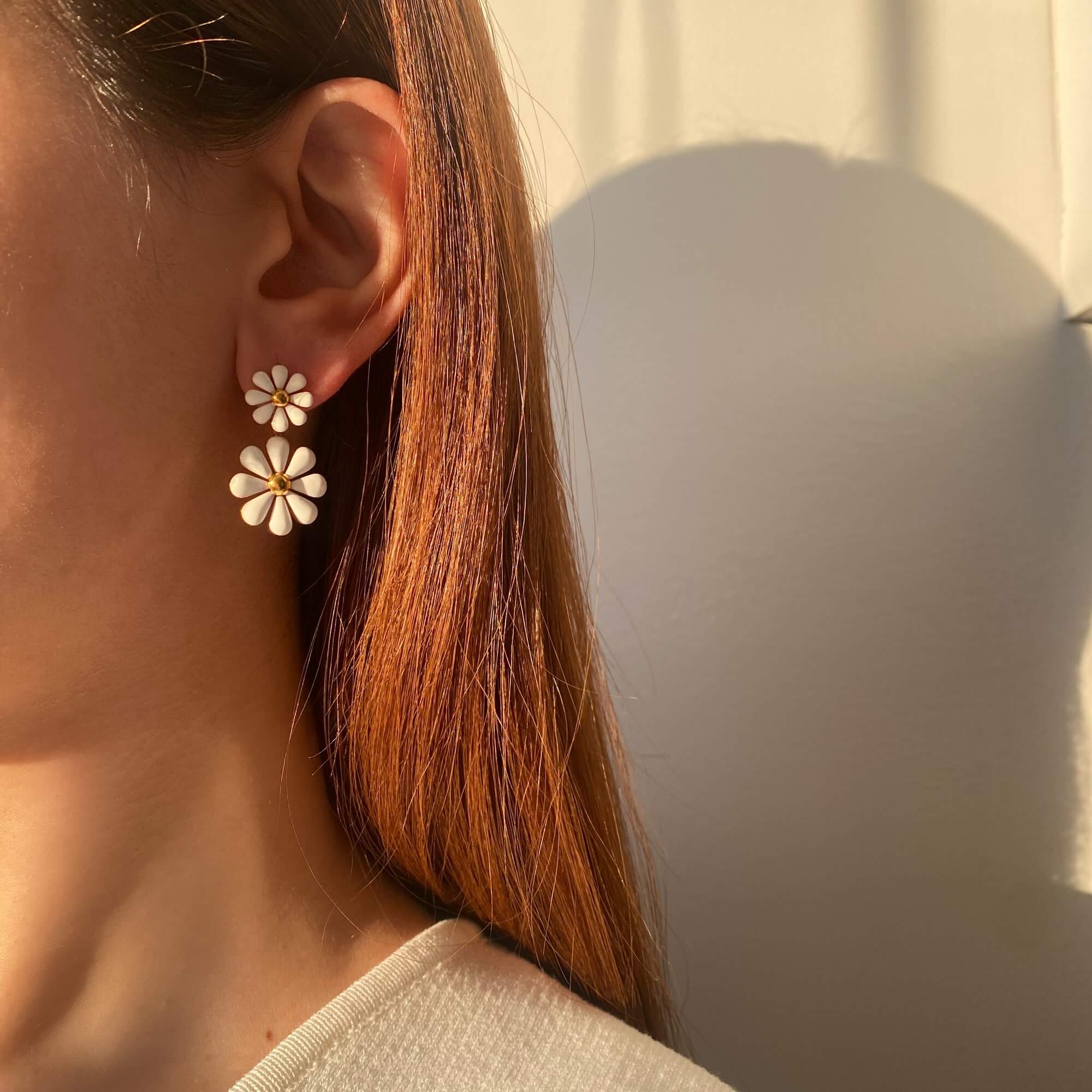 KendyR daisy drop earrings by Kampy Designs, styled on model’s ear to showcase their delicate floral shape and gentle swing motion.