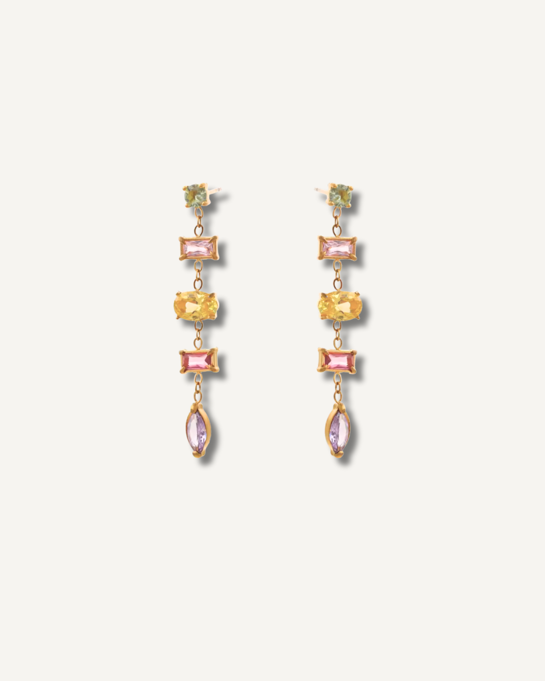 Pair of earrings with multicolored gemstones on a white background