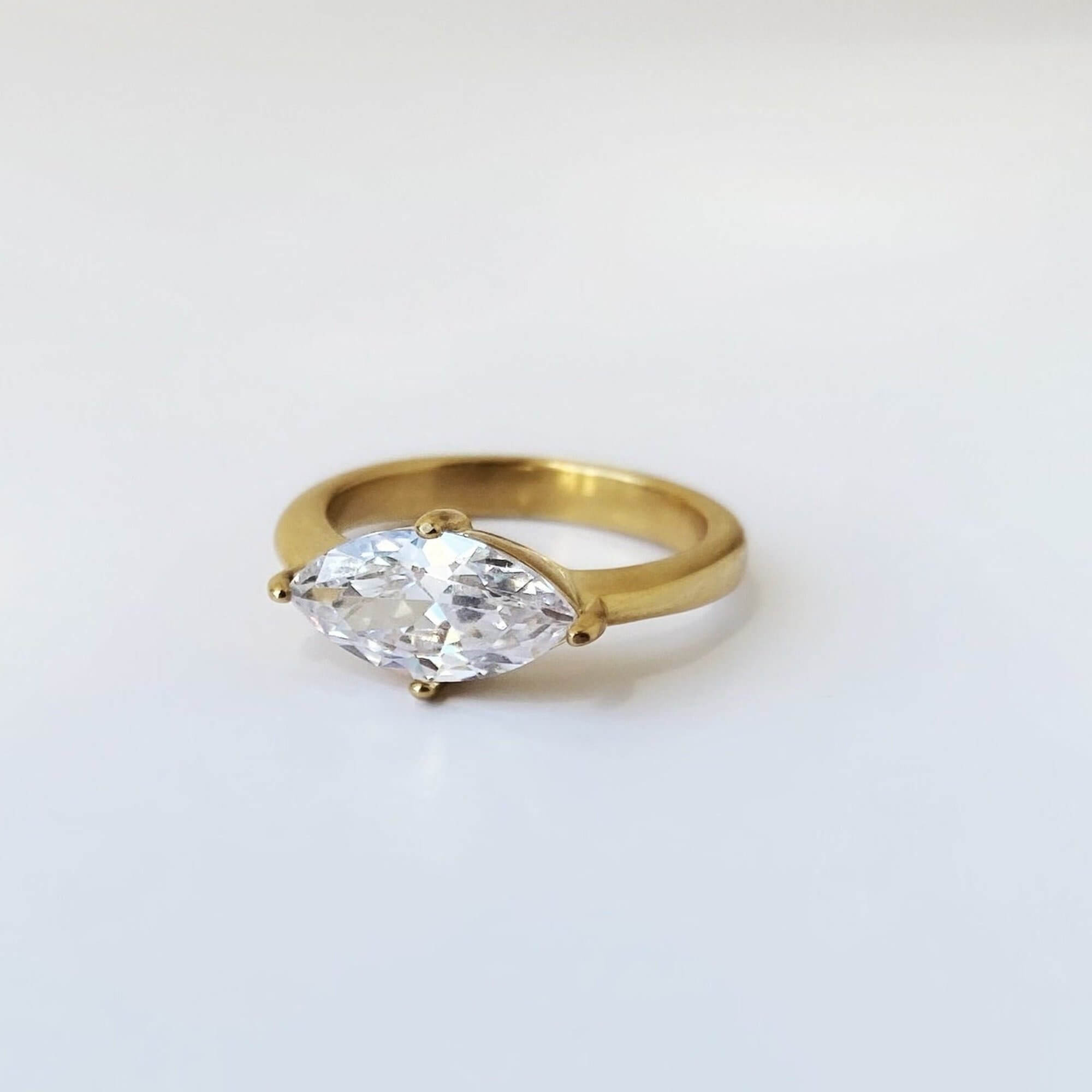 Front view of the KloneR east-west marquise engagement ring by Kampy Designs, featuring a sleek marquise-cut gemstone set horizontally for a modern touch.