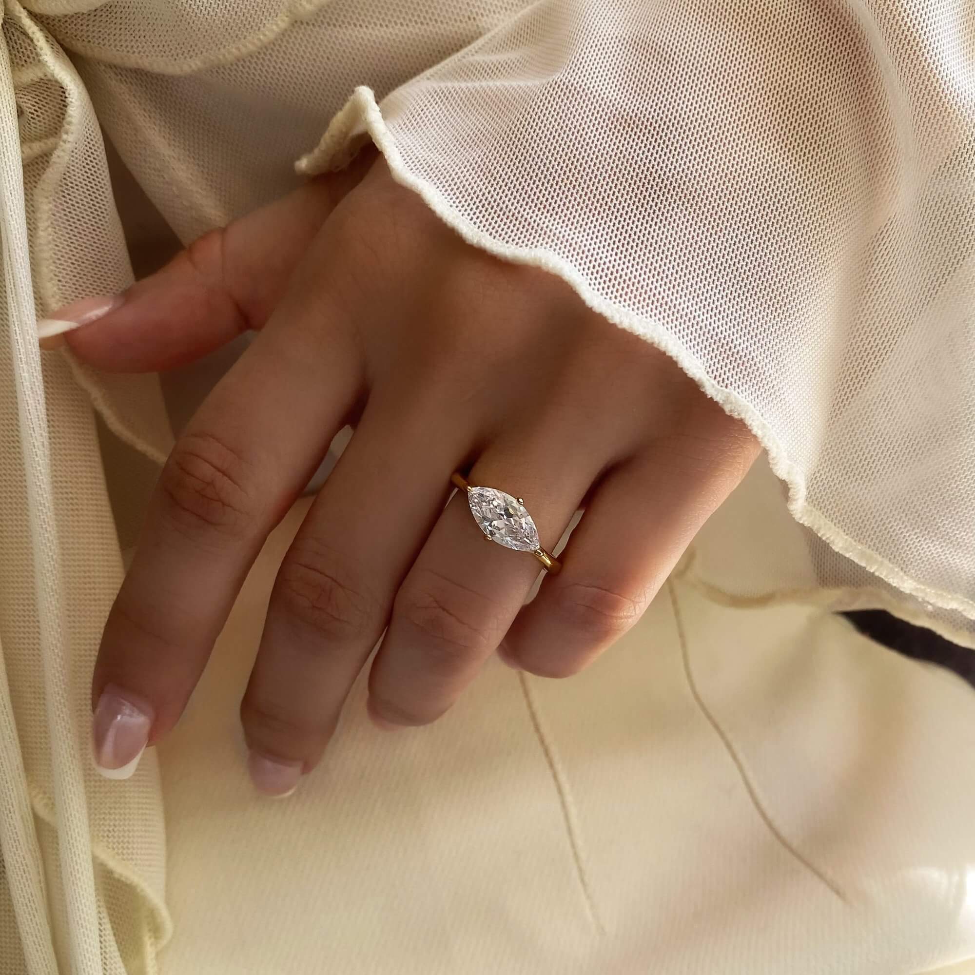 The KloneR east-west marquise engagement ring by Kampy Designs, elegantly worn to showcase its unique horizontal marquise-cut setting and sophisticated appeal.