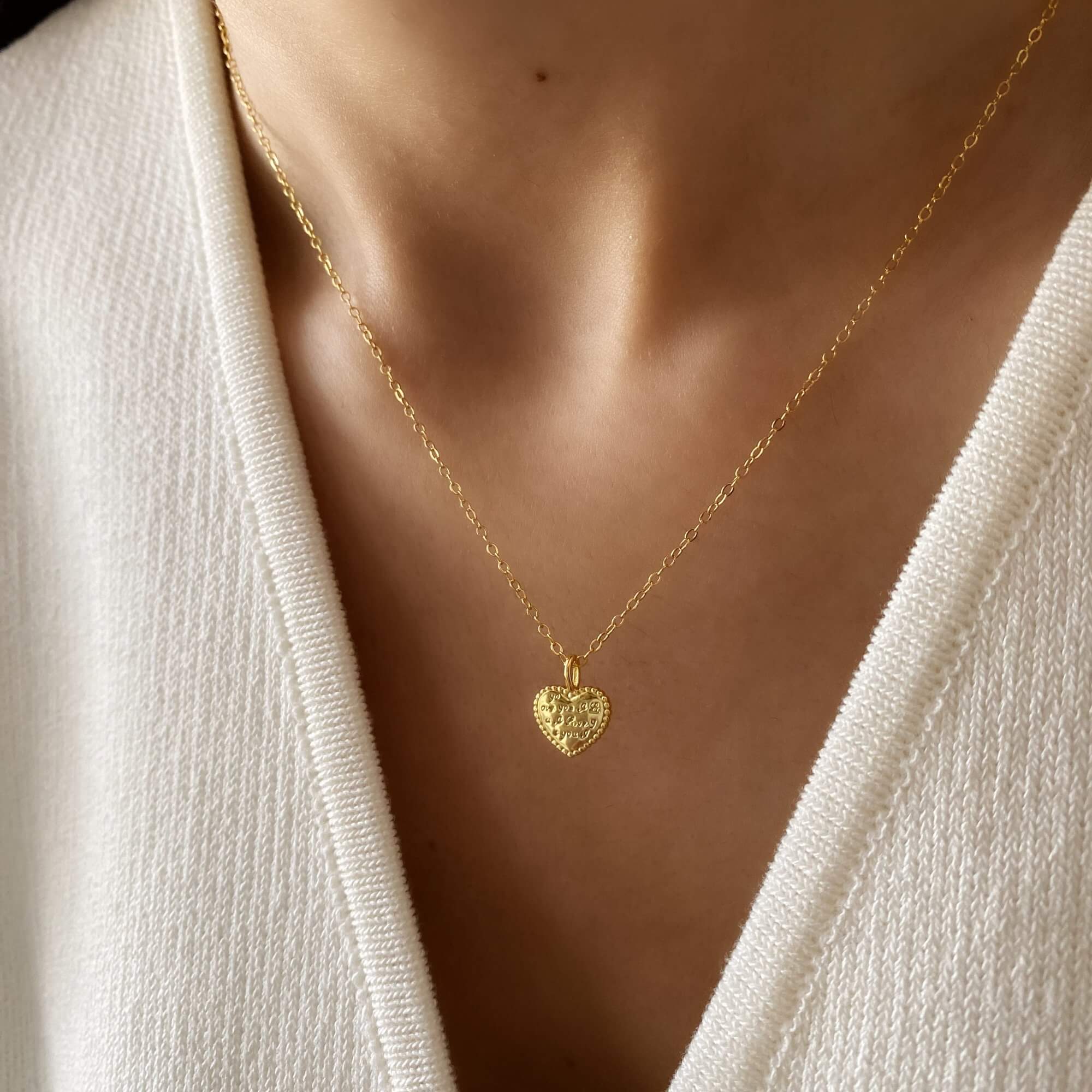 Close-up of the KatreenN engraved heart necklace by Kampy Designs, showcasing its intricate engraving and polished gold finish.