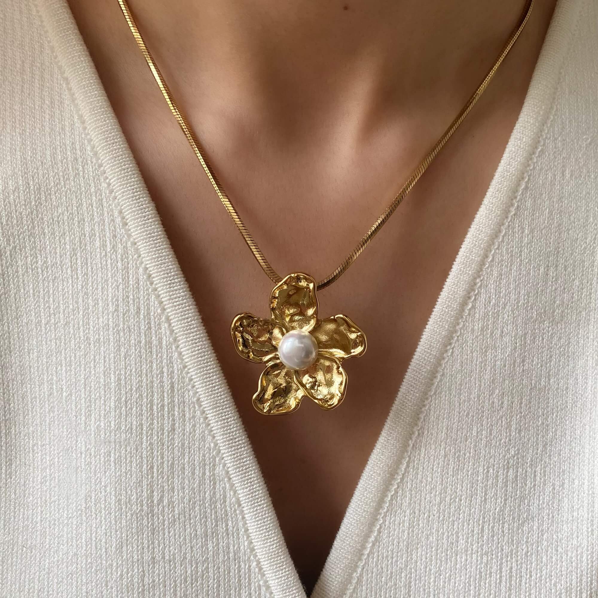 Close-up of the Kloran floral pearl pendant necklace by Kampy Designs, highlighting its delicate floral design and luminous pearl center.