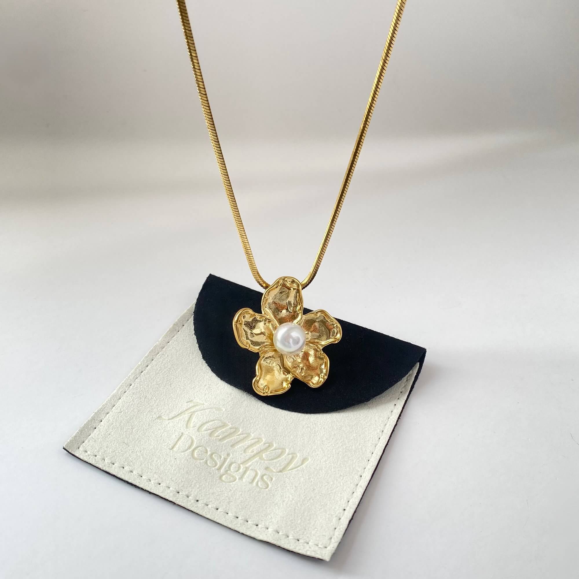 Dangle view of the Kloran floral pearl pendant necklace by Kampy Designs, capturing the movement and drop of the pearl pendant.
