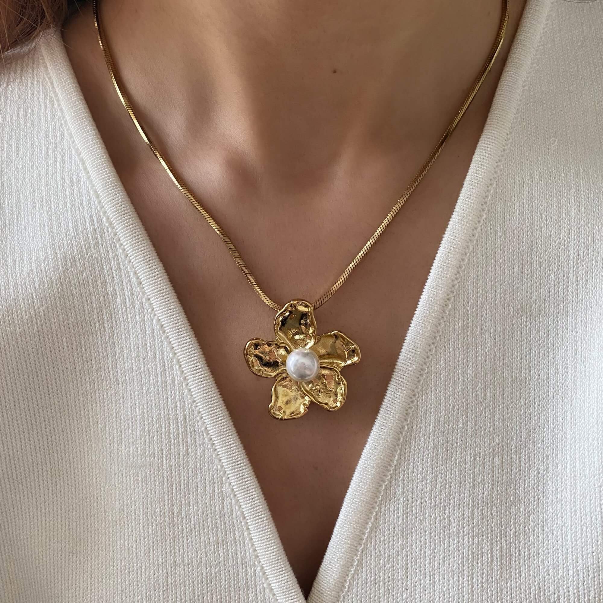 The Kloran floral pearl pendant necklace by Kampy Designs, worn by model to highlight its graceful fall and soft feminine touch.