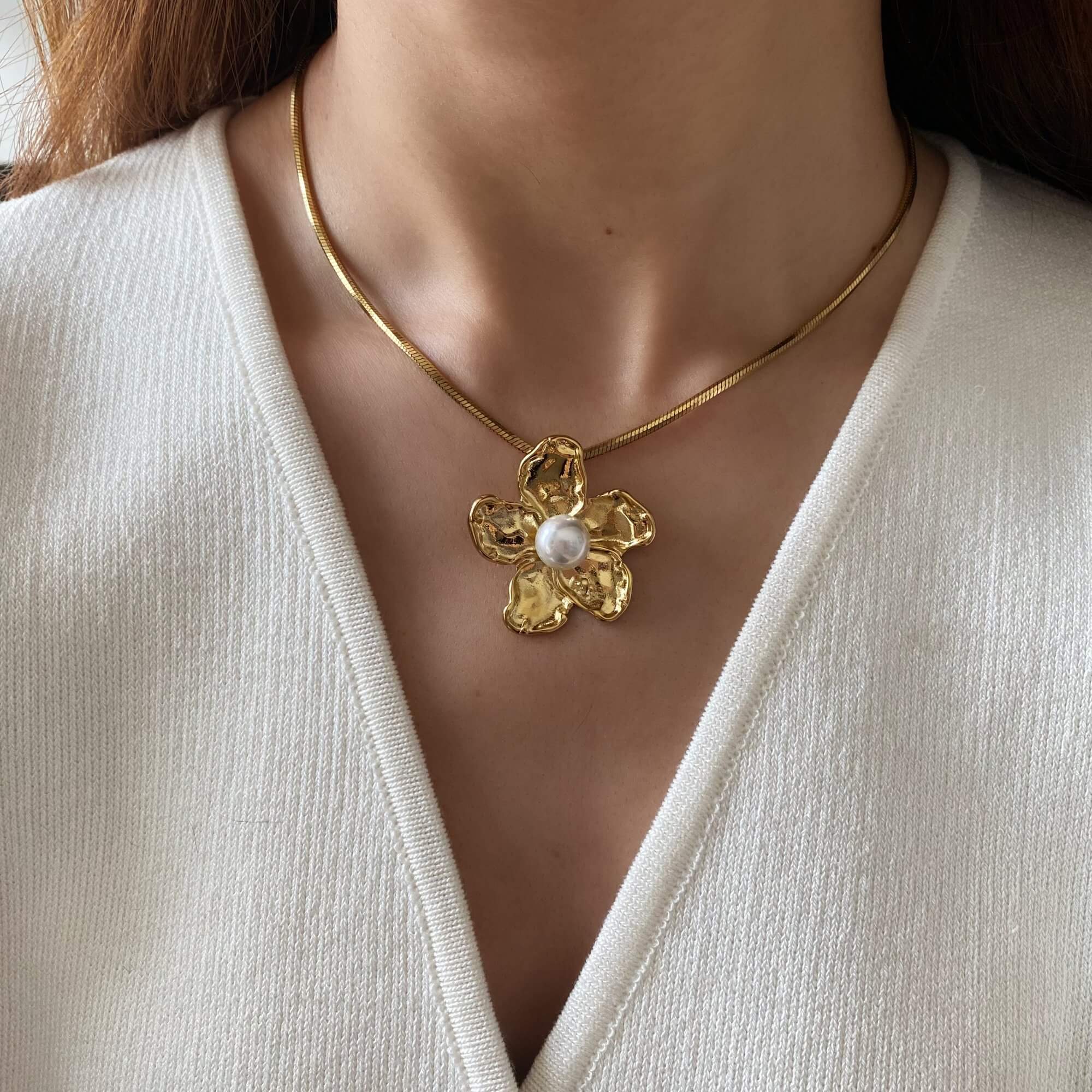 Close-up on model’s neck wearing the Kloran floral pearl pendant necklace by Kampy Designs, showing its flattering fit and romantic design.