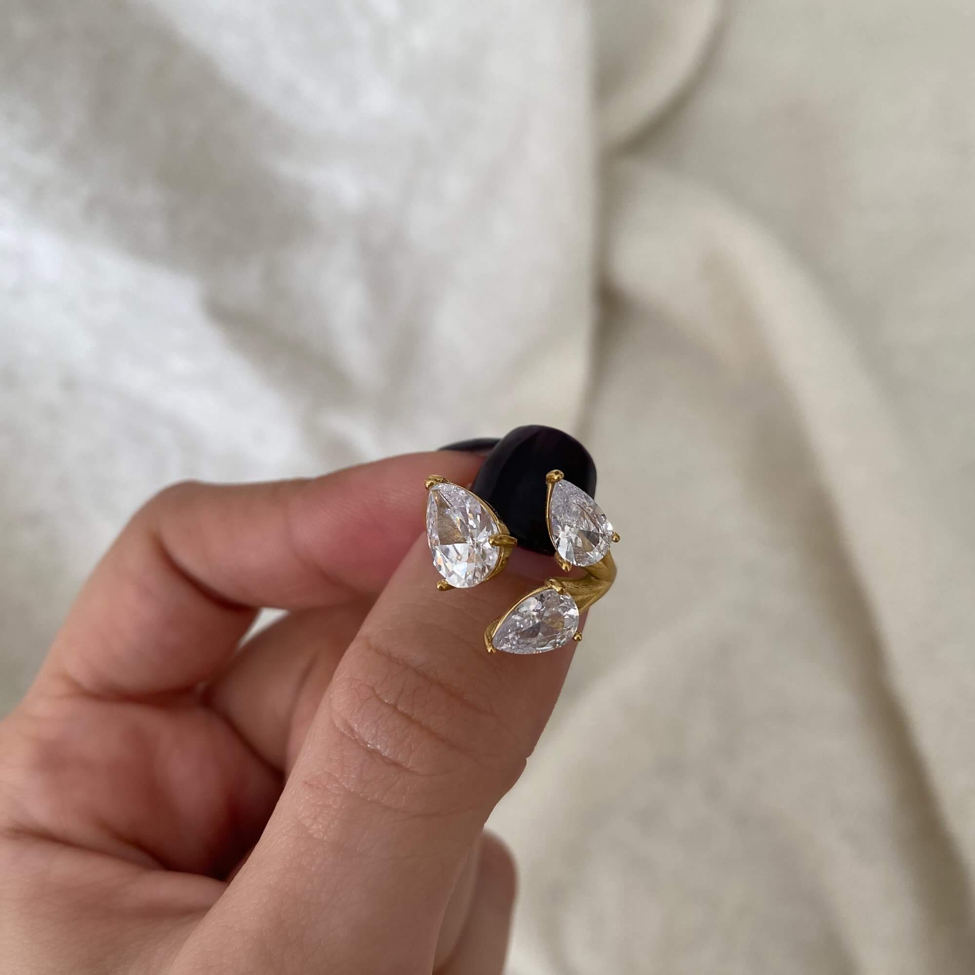 The KipsyR floral vine ring by Kampy Designs, held by model to highlight its textured floral motifs and refined gold finish.