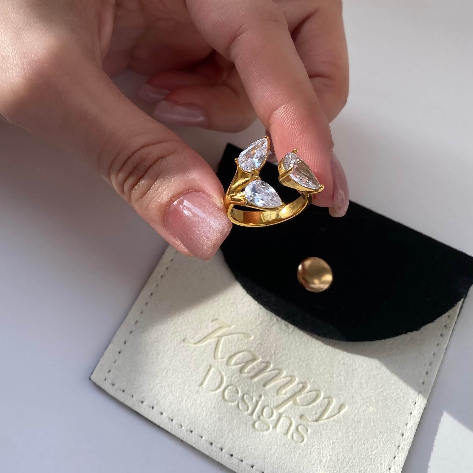 Top view of the KipsyR floral vine ring by Kampy Designs, placed on branded packaging to emphasize premium craftsmanship and presentation.