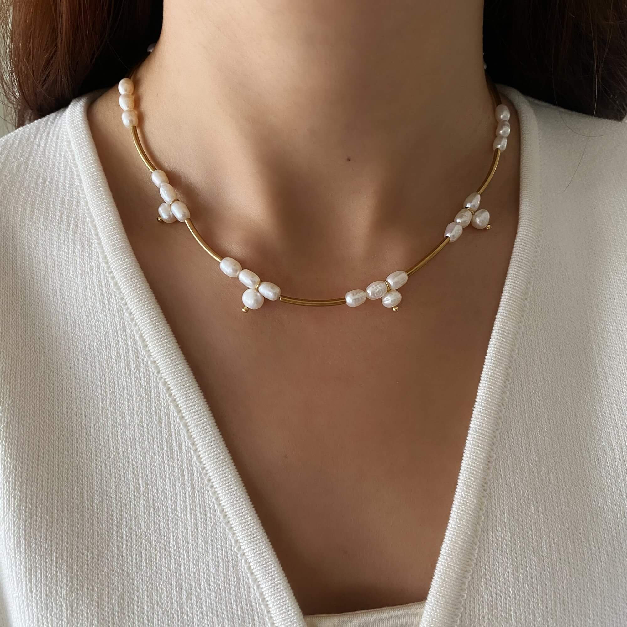 The KlamN freshwater pearl boho chain necklace by Kampy Designs, beautifully worn to highlight its delicate pearl charms and free-spirited design.