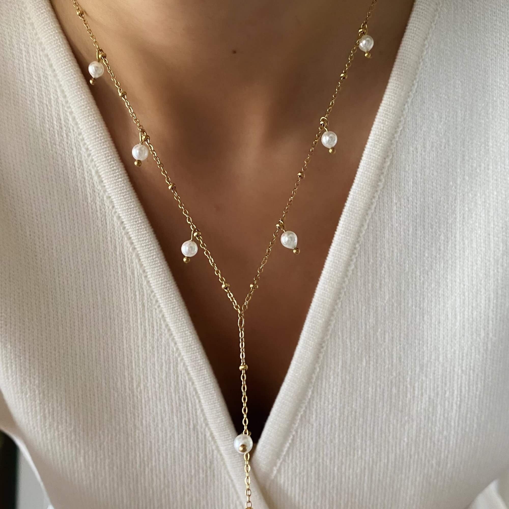 Close-up of the KleopatraN freshwater pearl charm lariat necklace by Kampy Designs, highlighting its delicate pearl charm and elegant drop design.