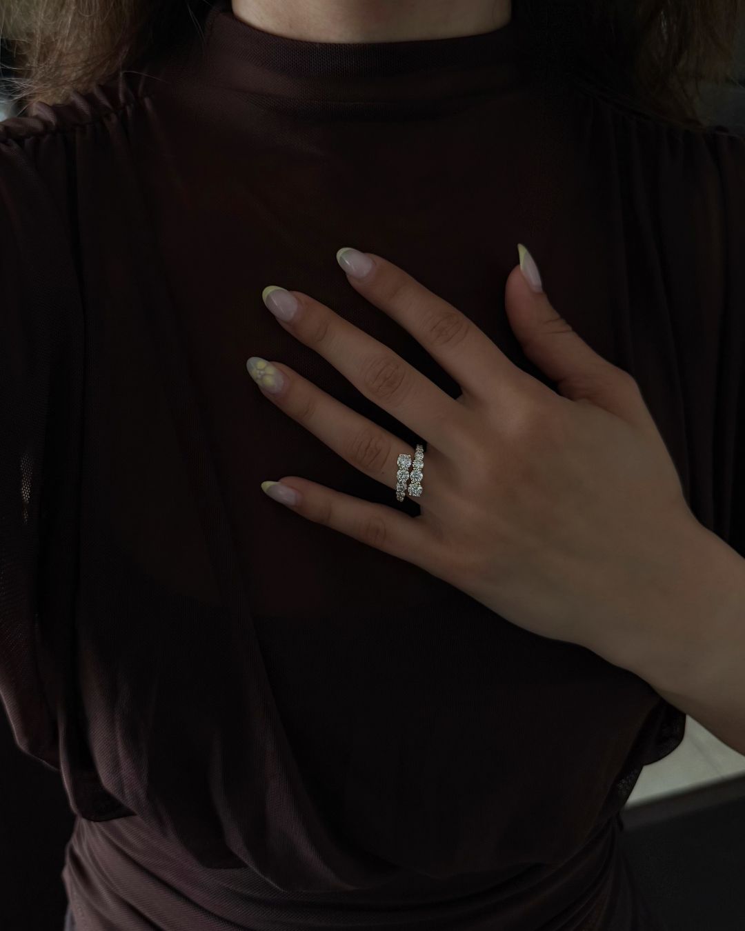 Gold moissanite open wrap ring styled with a sheer burgundy outfit.