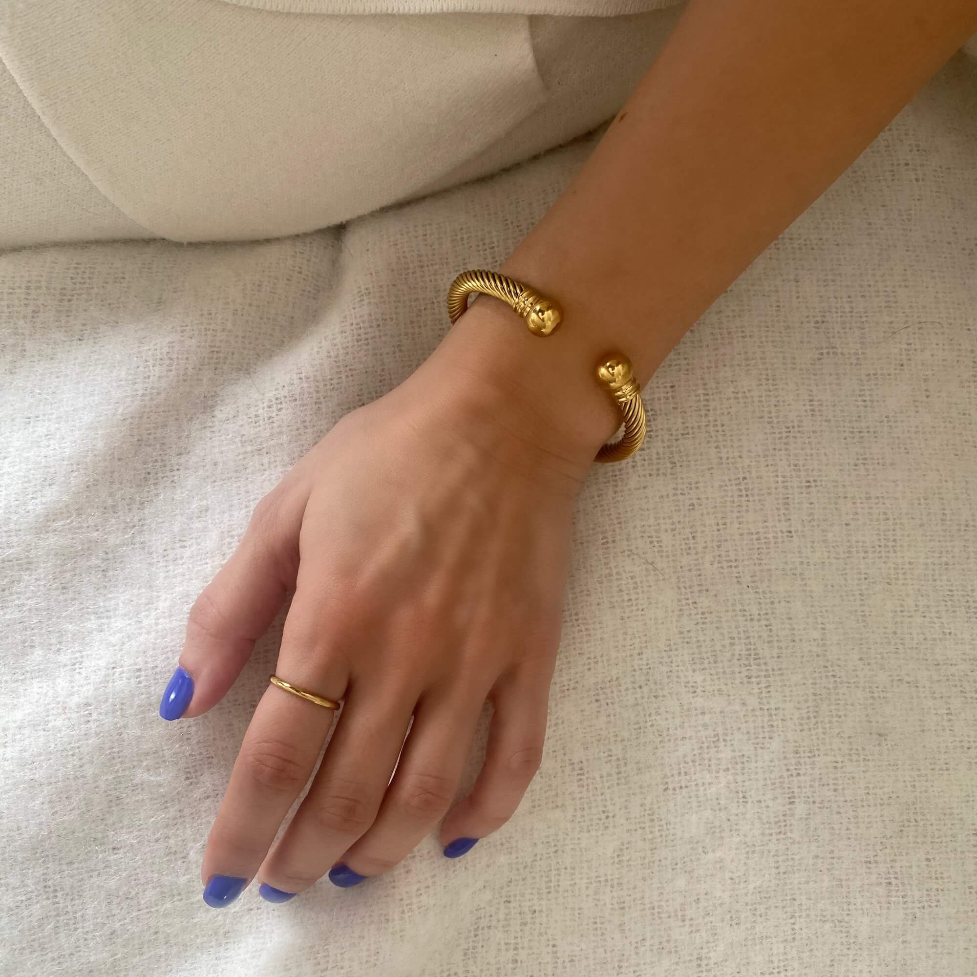 Styled view of the KammyB gold twist cuff bracelet by Kampy Designs, paired with other accessories for a chic and luxurious ensemble.