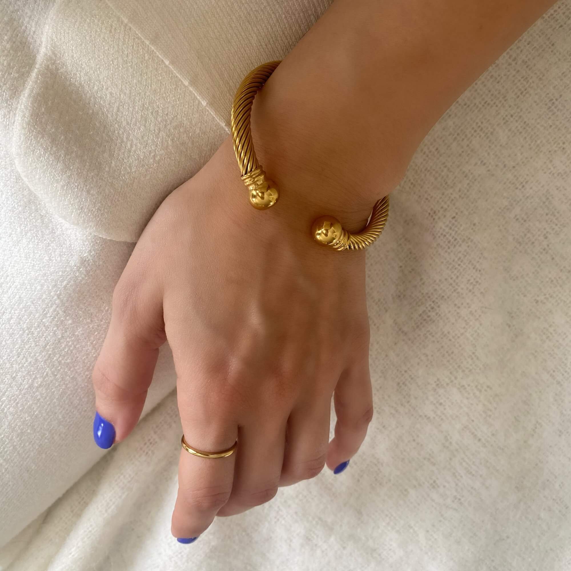 Top-down view of the KammyB gold twist cuff bracelet by Kampy Designs, highlighting the symmetry and fine detailing of the twisted band.