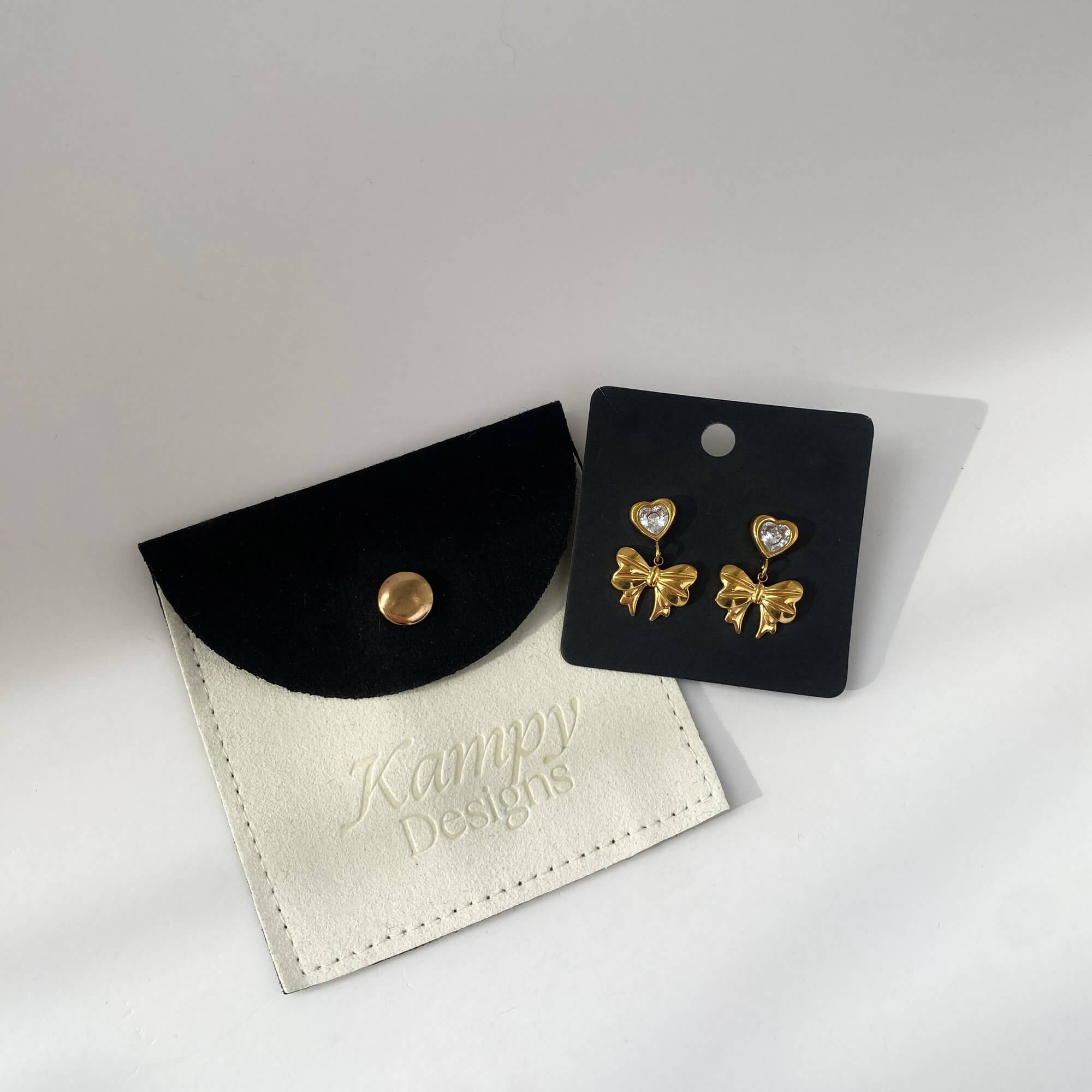 KutieE heart bow dangle earrings by Kampy Designs, beautifully arranged on branded packaging, perfect for gifting.