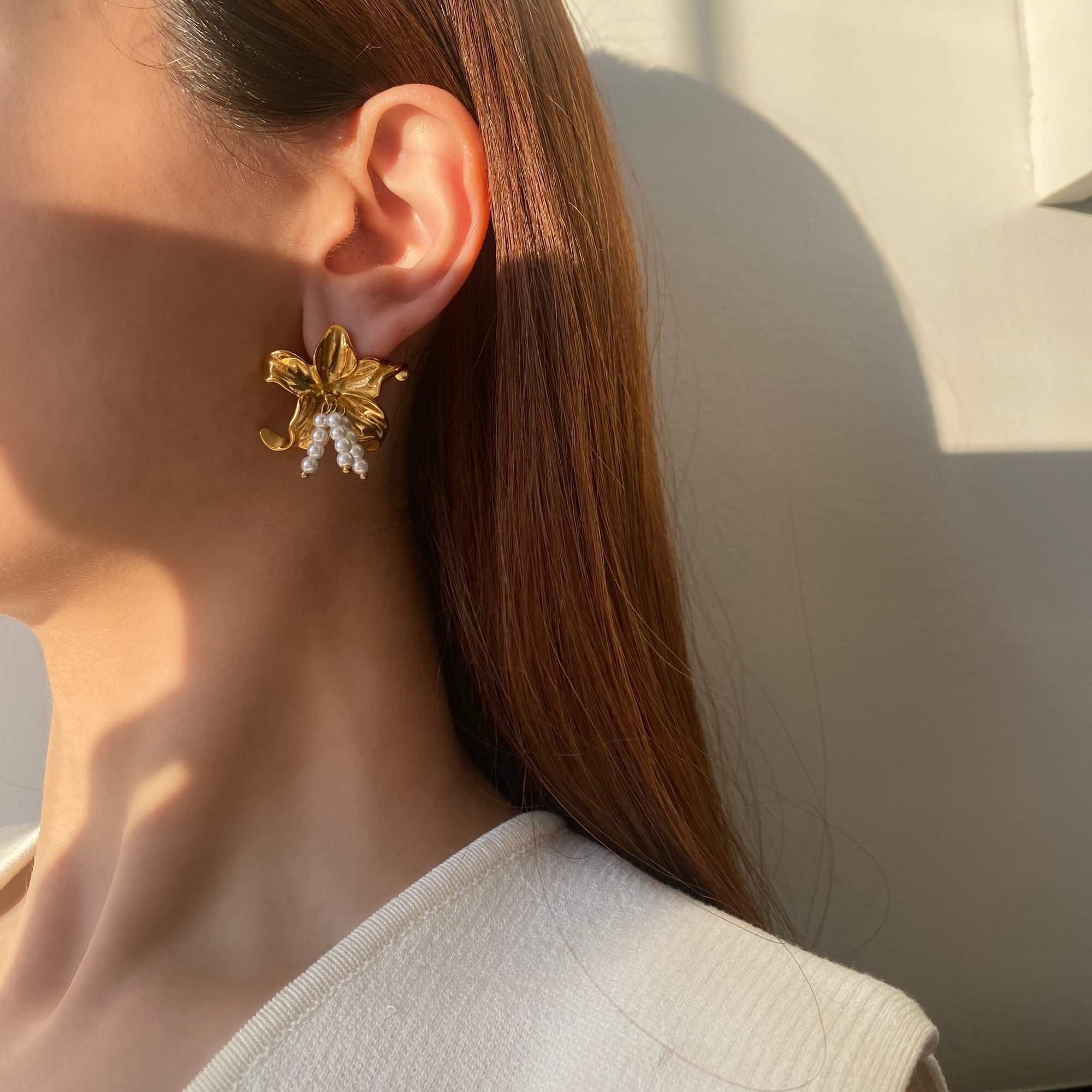 Angled view of the Kawaiie hibiscus flower stud earrings by Kampy Designs, highlighting the layered petals and realistic floral design.