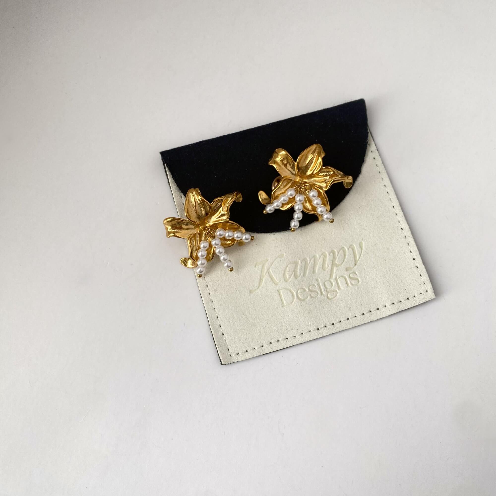 Kawaiie hibiscus flower stud earrings by Kampy Designs, styled flat on branded packaging for a premium presentation look.