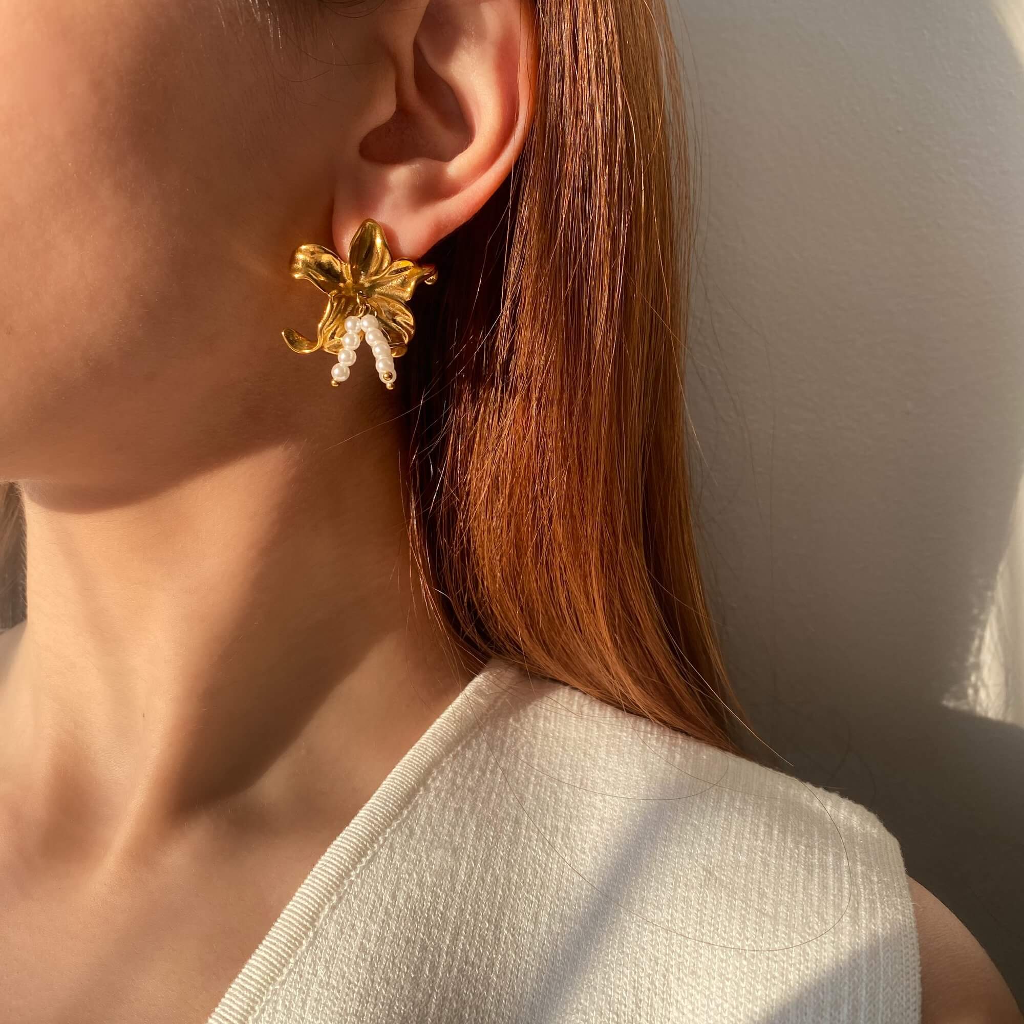 Far view of the Kawaiie hibiscus flower stud earrings by Kampy Designs, revealing their dainty yet eye-catching appearance.