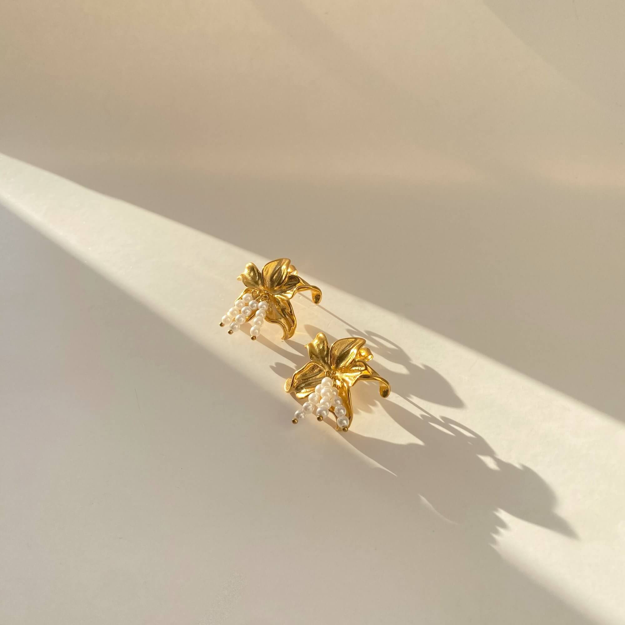 Flat lay of Kawaiie hibiscus flower stud earrings by Kampy Designs, displayed neatly to show symmetry and soft petal contours.