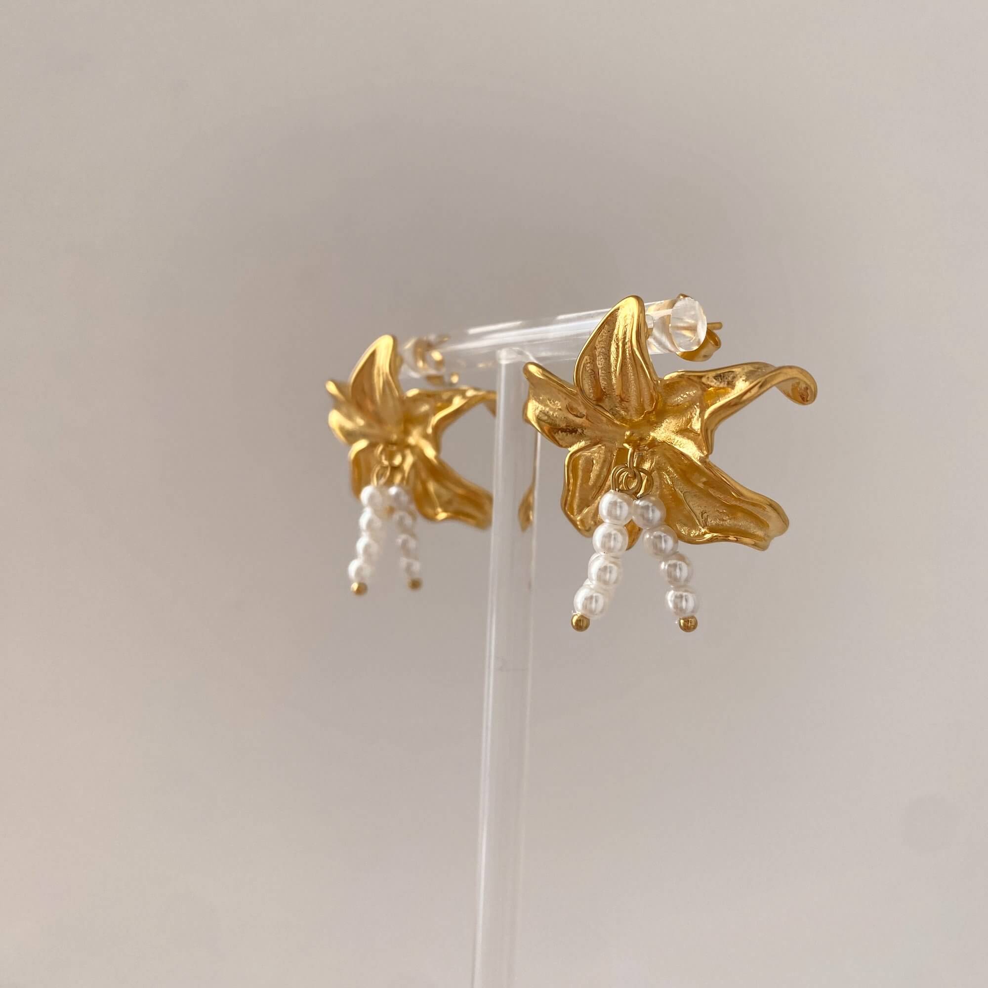 Side-angled shot of Kawaiie hibiscus flower earrings by Kampy Designs, showing raised petal shape and natural design curvature