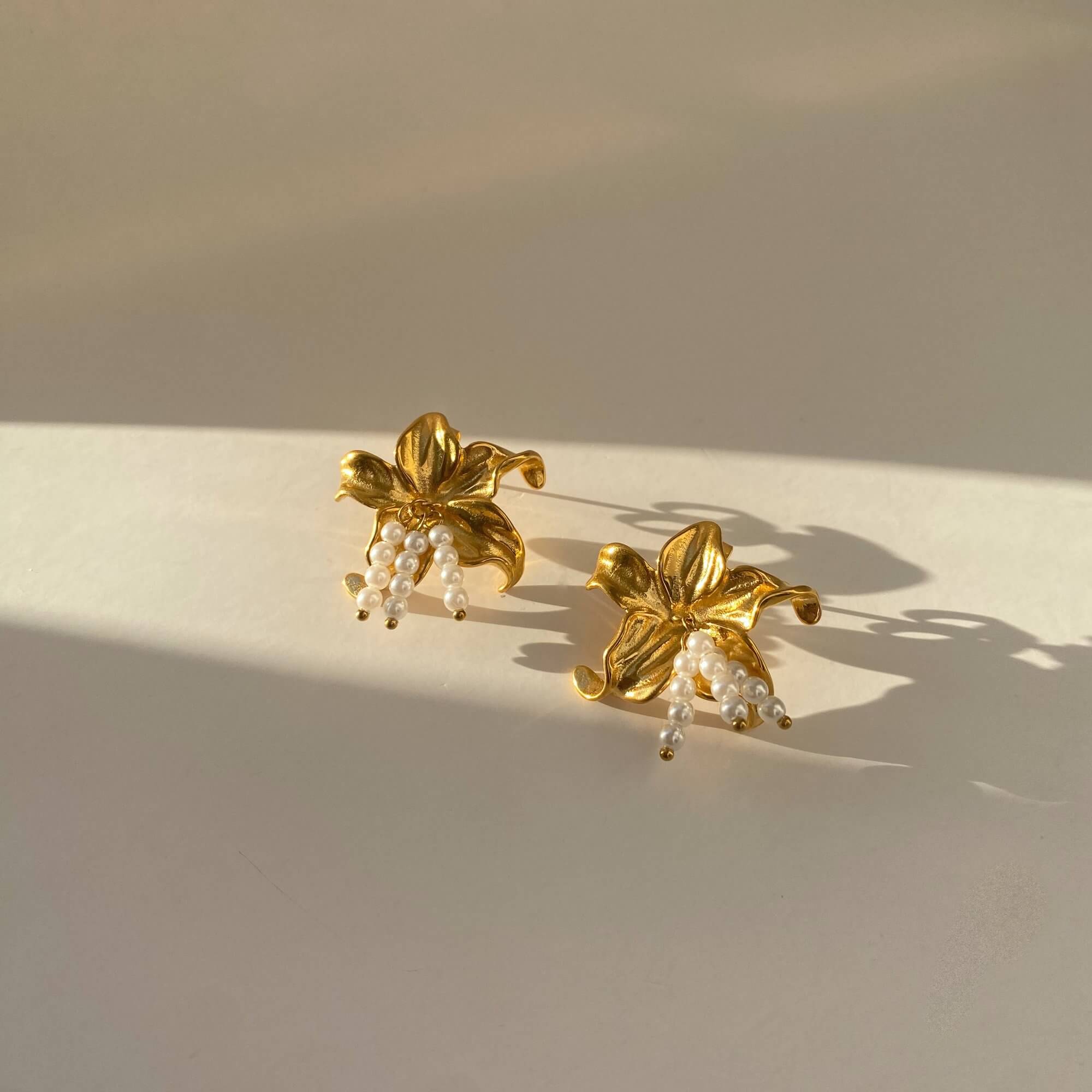 Side profile of the Kawaiie hibiscus flower stud earrings by Kampy Designs, emphasizing their dimension and gold hardware backing.