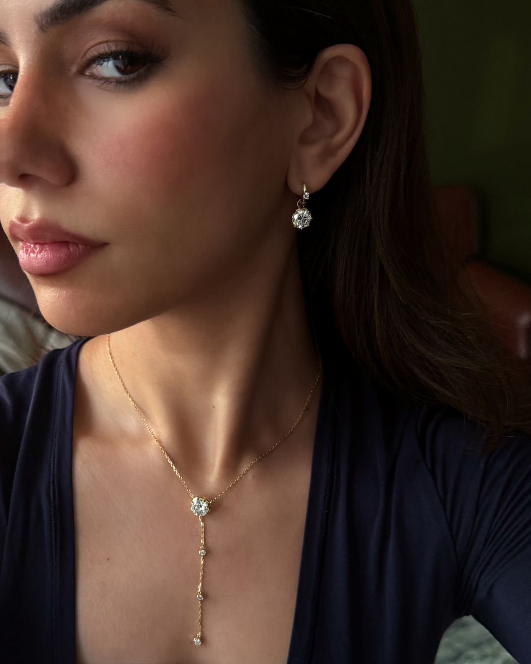 Model wearing the Lumina Drop Necklace with matching Lumina Drop Earrings in gold-plated sterling silver and moissanite.