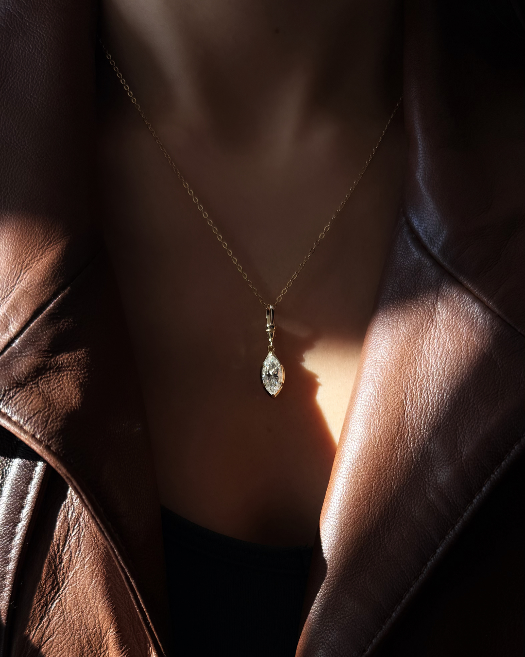 Marquise white moissanite pendant necklace layered with other gemstone pendants showing size and sparkle by Kampy