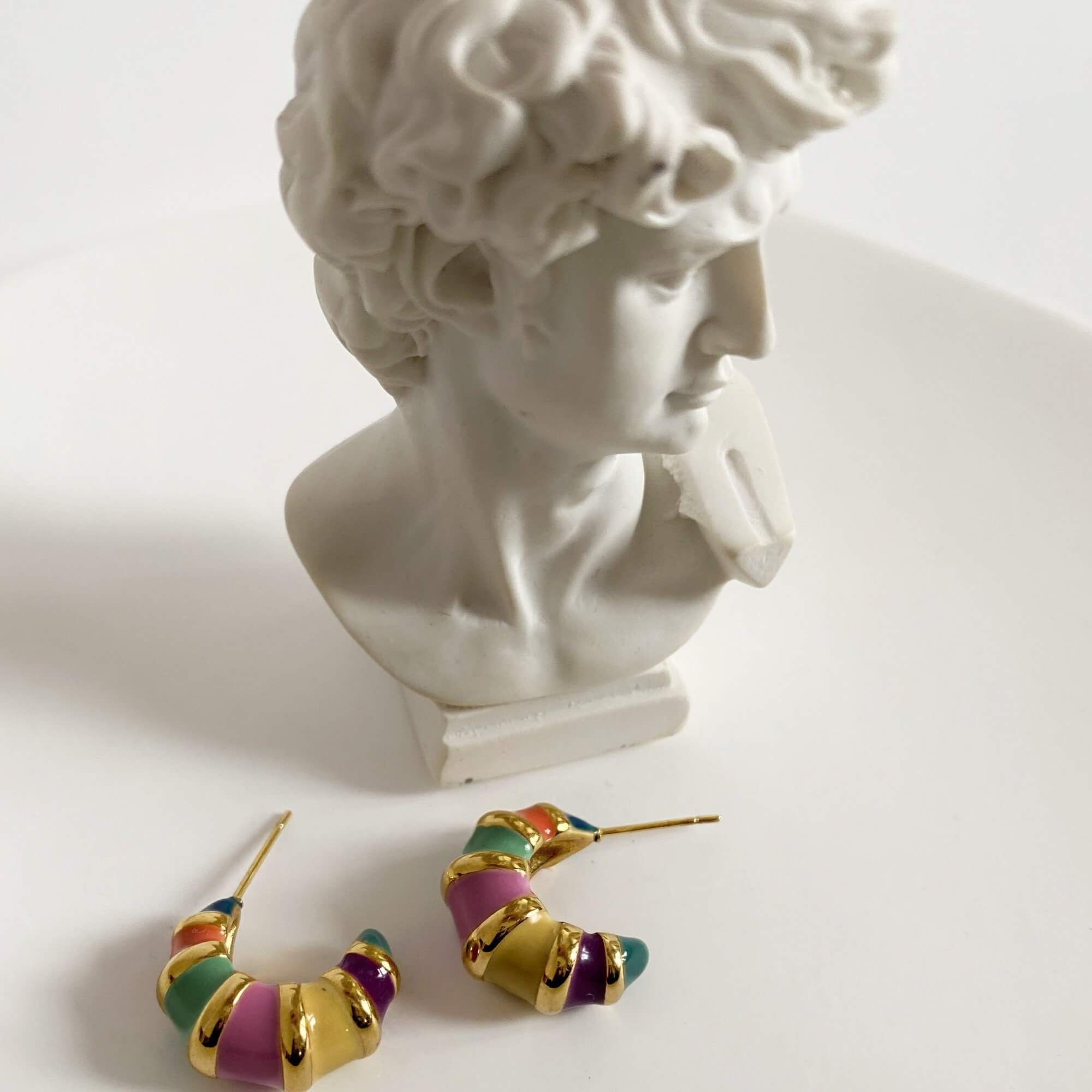 Top view of the KrosantE multi-color enamel hoop earrings by Kampy Designs, displaying their sleek circular shape and multi-tone enamel detailing.