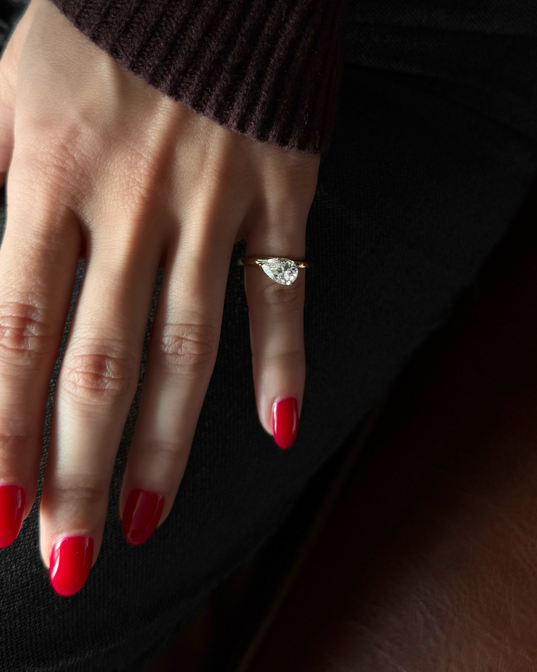 Close up of east-west floating wave ring worn on model pinky, Kampy Designs