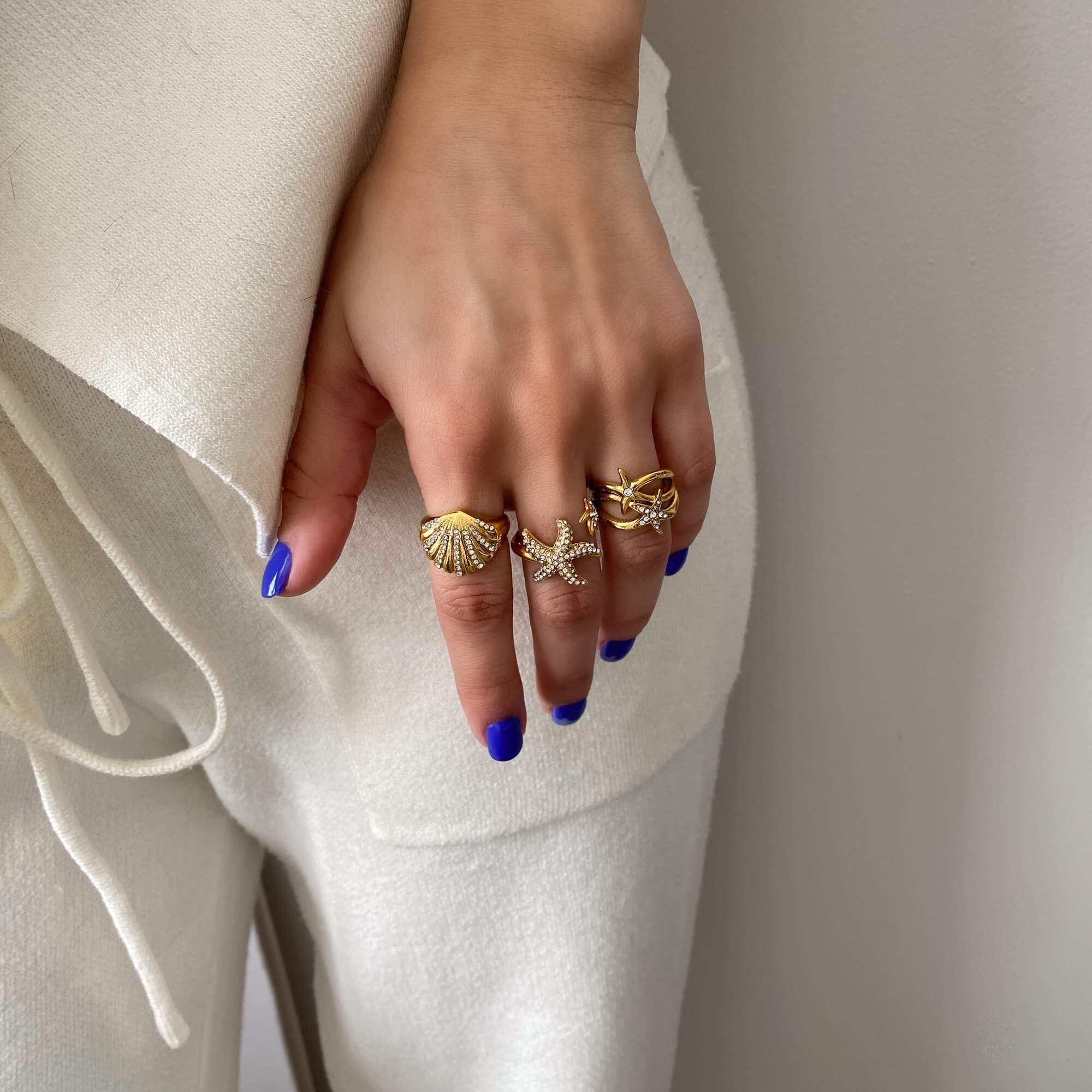 Stacked view of the Ocean Ring Set by Kampy Designs on model's hand, capturing their unity and flowing design.