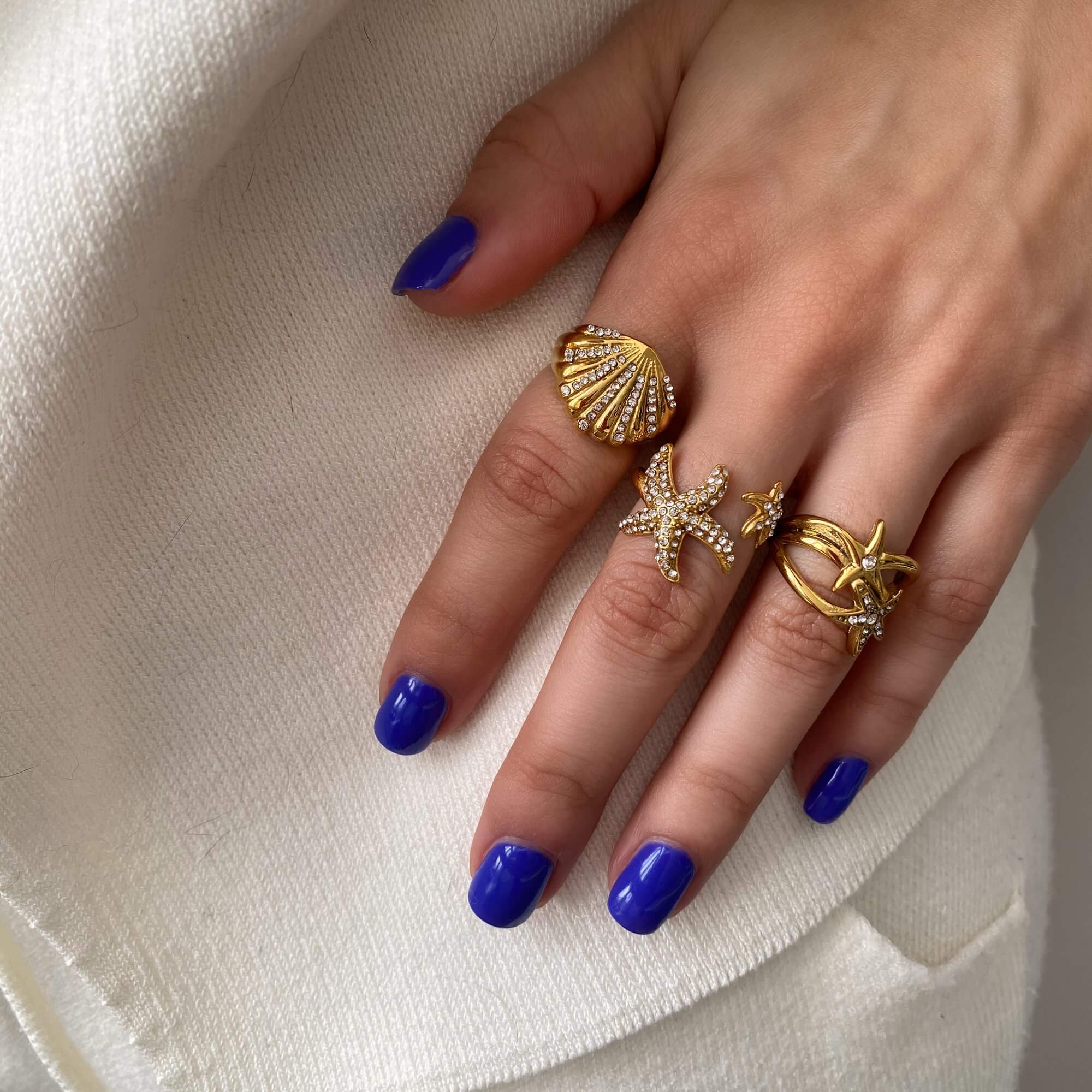 Model holding Design B from the Ocean Ring Set by Kampy Designs, offering a tactile glimpse of the ring’s gentle curves.