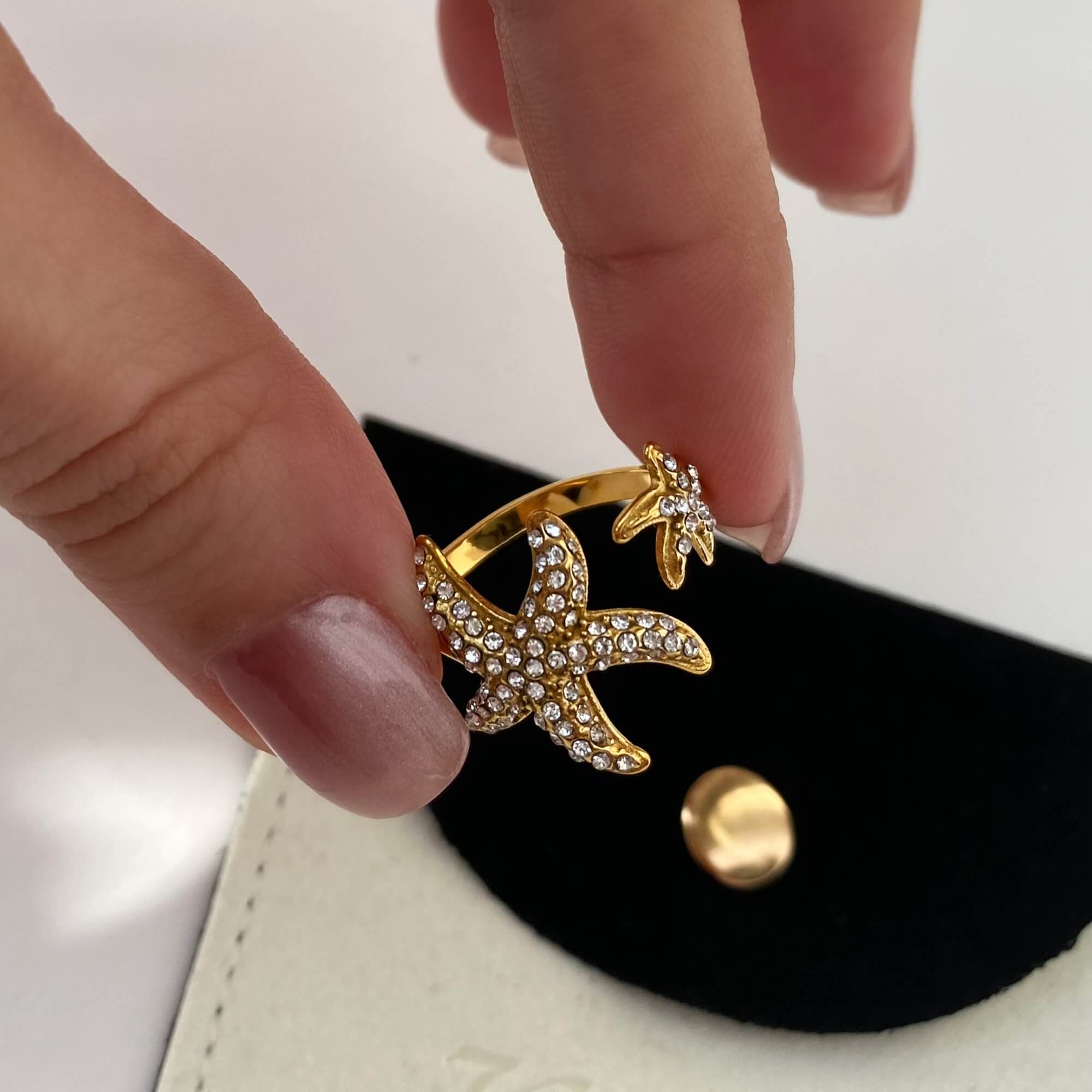 Model holding all rings from the Ocean Ring Set by Kampy Designs, showcasing their unique textures and complementary shapes.