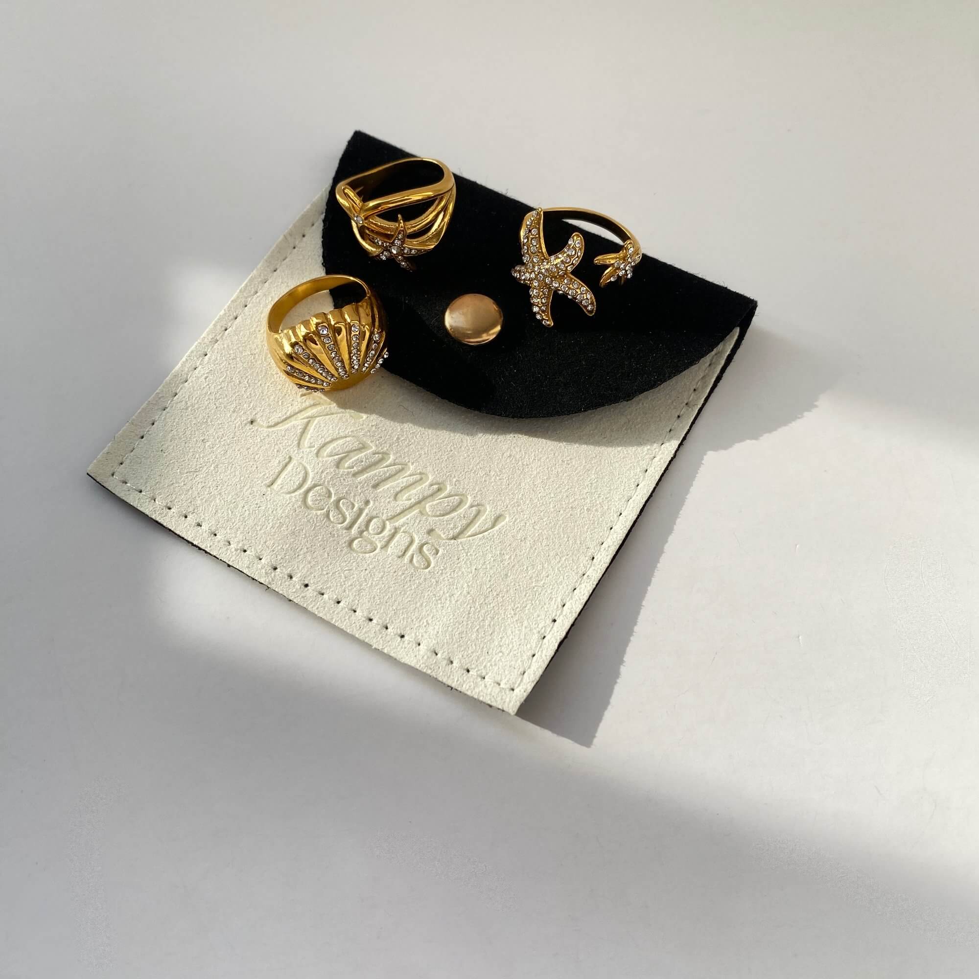 Close-up shot of the Ocean Ring Set by Kampy Designs, emphasizing their wave-inspired artistry and gold-tone textures.