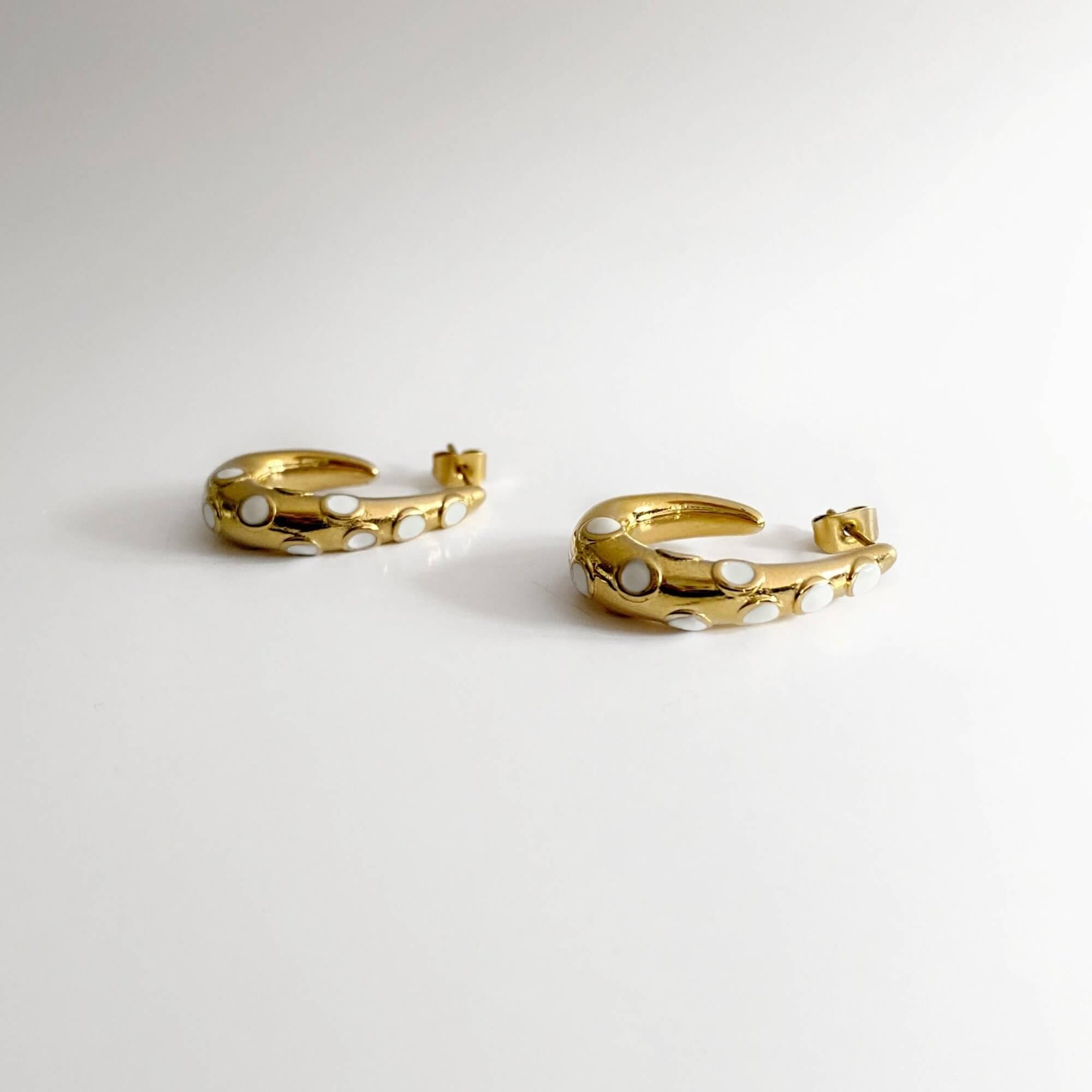 Side view of the KoctiE octopus tentacle gold hoop earring by Kampy Designs, showcasing its curved tentacle design with intricate detailing.