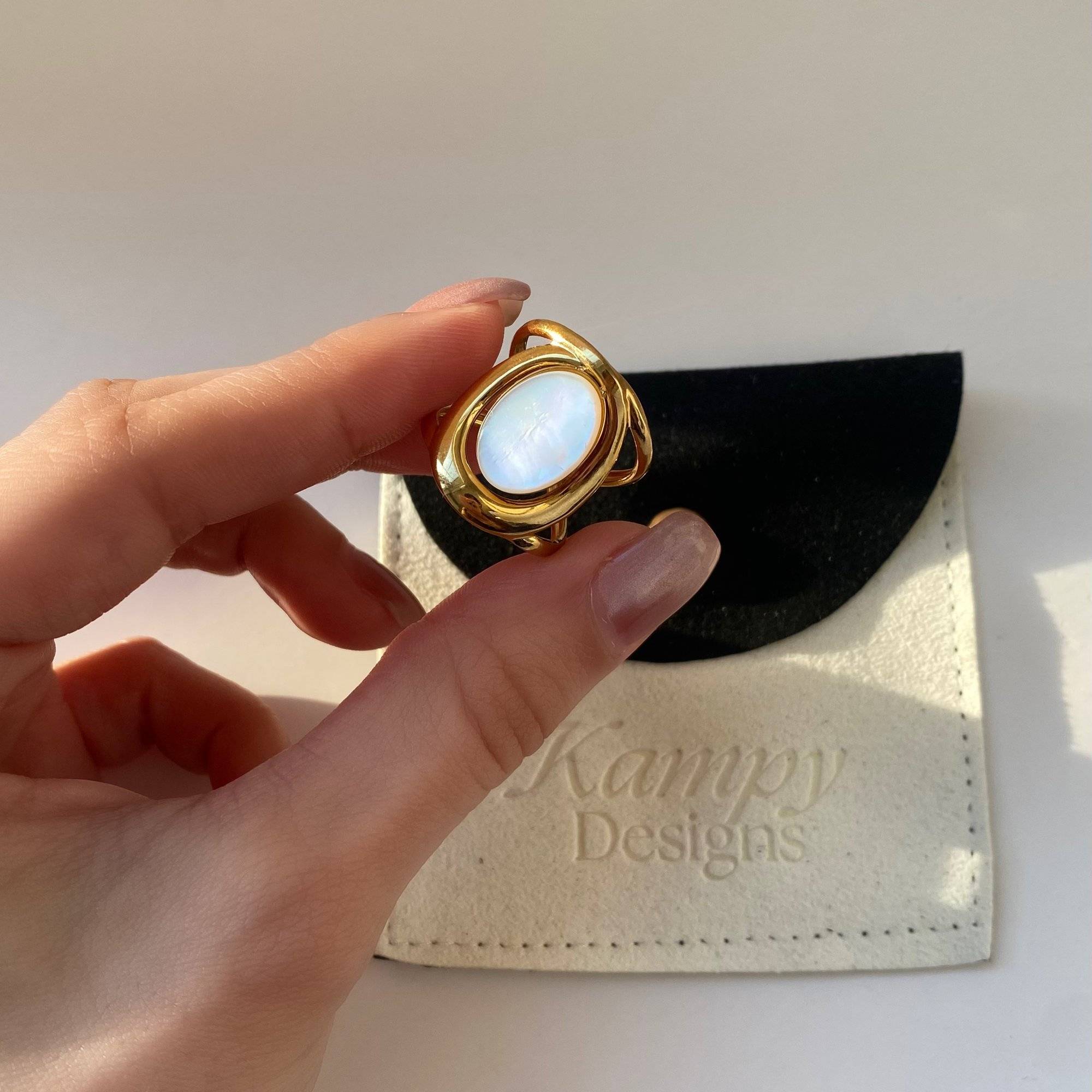 Full view of Kostar opal split shank ring by Kampy Designs, worn on model's finger to highlight the unique double-band design with iridescent opal.