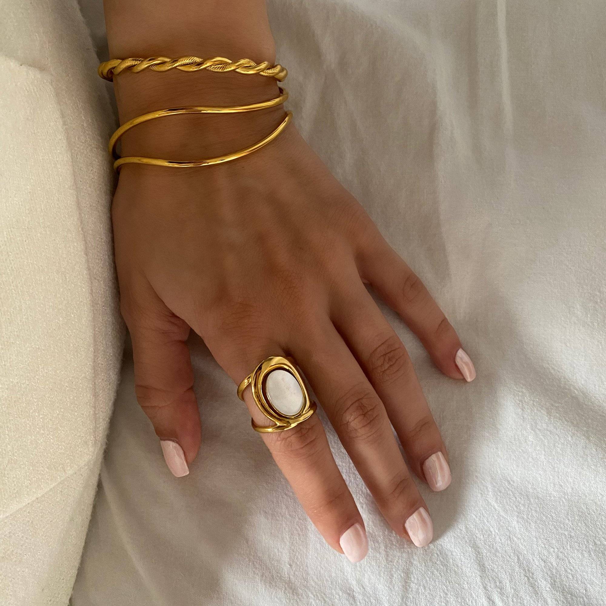 Kostar opal split shank ring by Kampy Designs, worn on model’s finger for a simple, elegant appearance.
