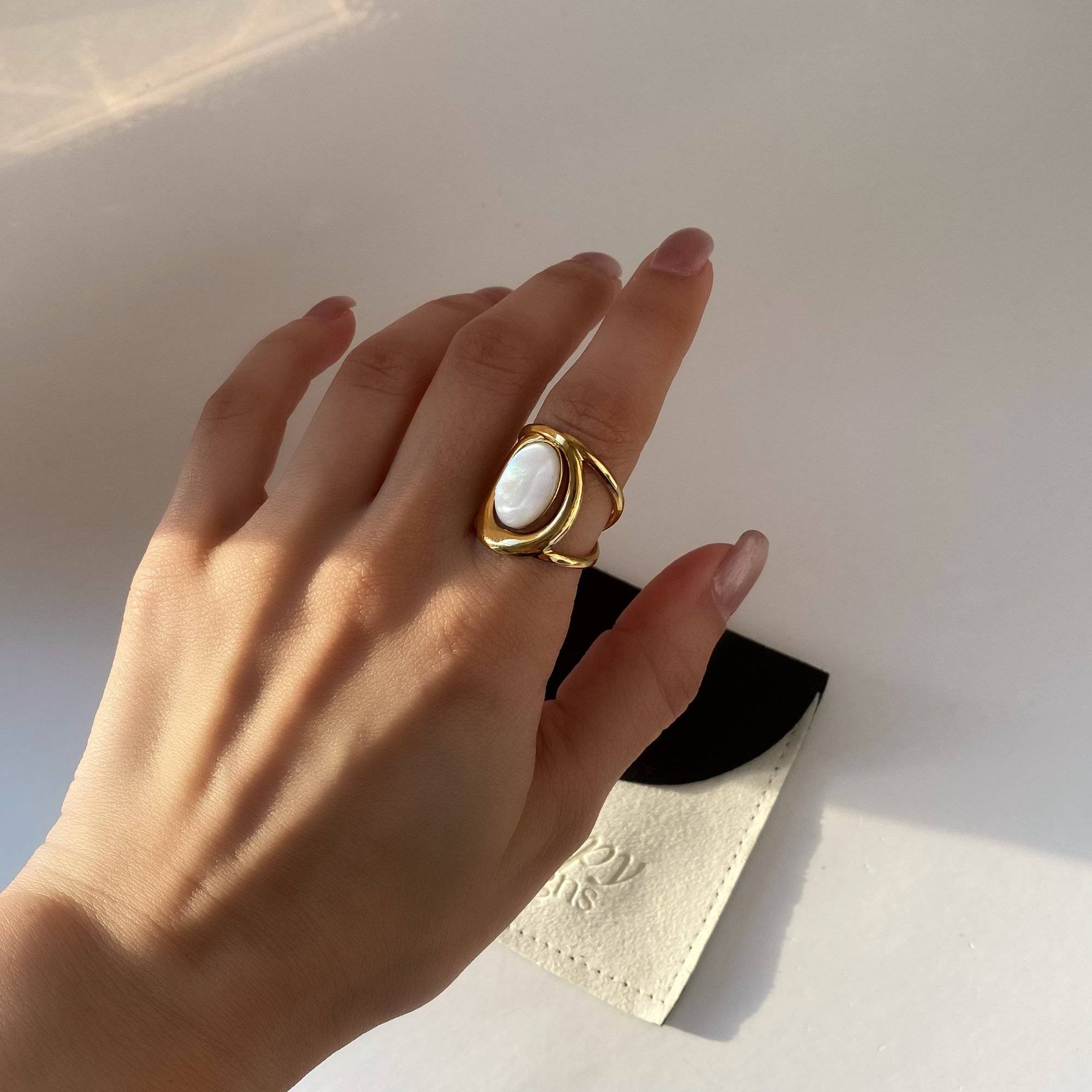 Kostar opal split shank ring by Kampy Designs, worn on model's hand in natural lighting to showcase the opal’s shimmer and clean split-band setting.
