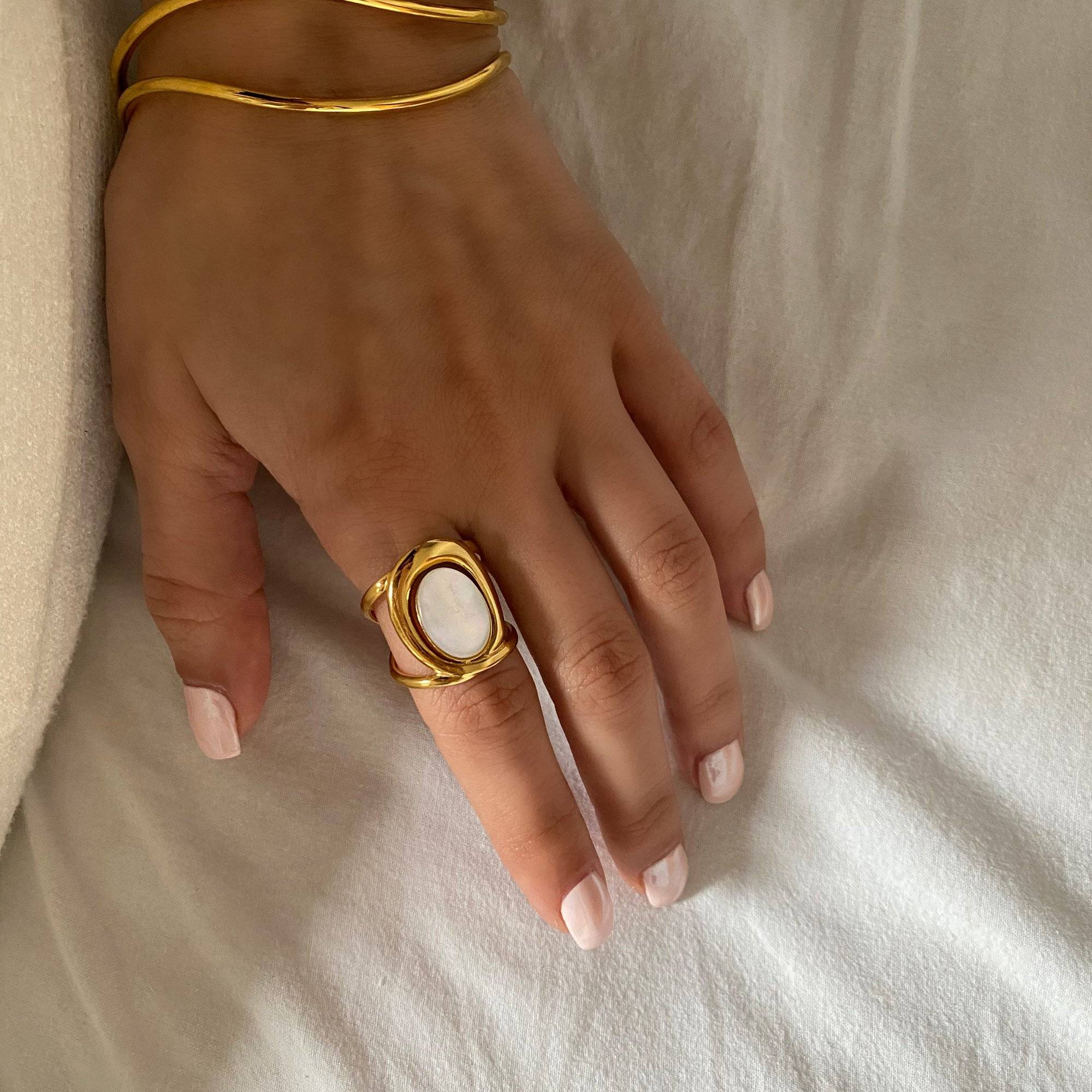 Kostar opal split shank ring by Kampy Designs, stacked with other rings to create a contemporary layered style.